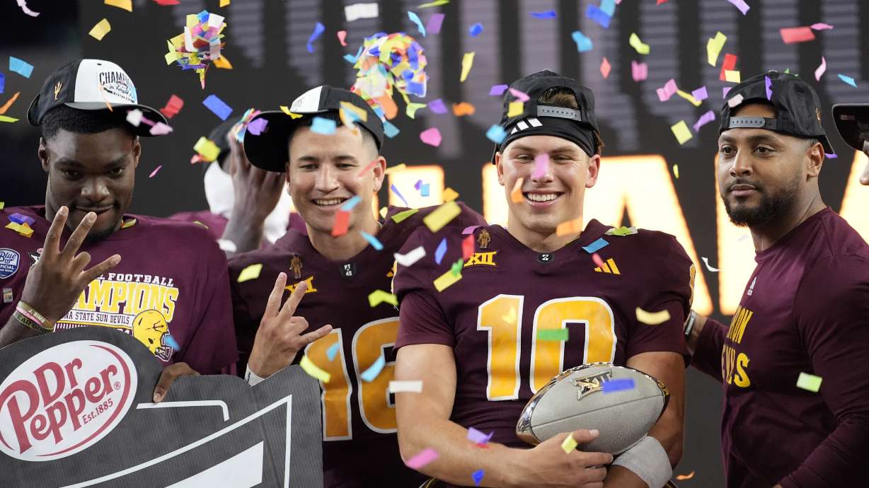 Arizona State quarterback Sam Leavitt (10) celebrates with teammates after the team's win in the Big 12 Conference championship NCAA college football game against Iowa State, in Arlington, Texas, Saturday Dec. 7, 2024.