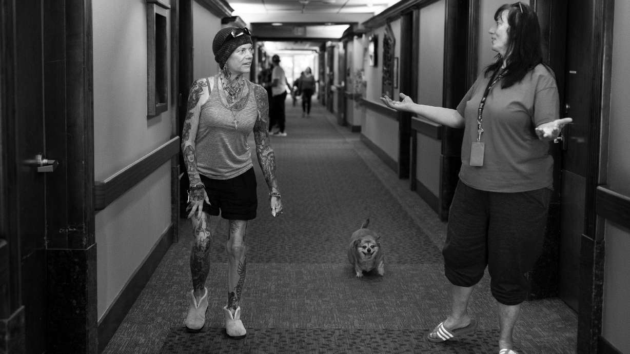 INN Between resident Stephanie Baker, left, walks BooBoo back to Kimberley Peterson’s room at the facility in Salt Lake City on Sept. 6, 2023. Peterson inherited BooBoo after her owner died at the inn.