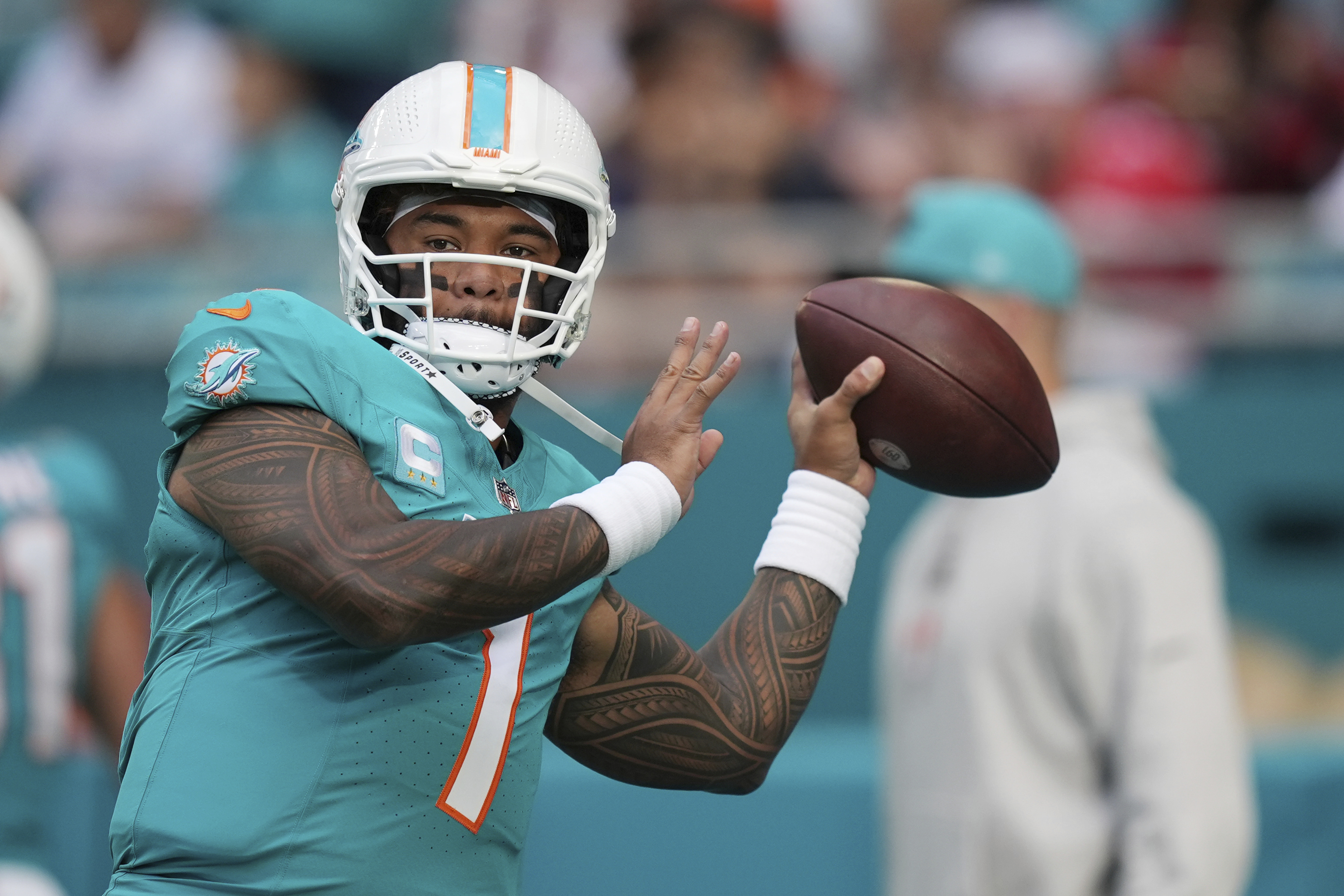 Miami Dolphins quarterback Tua Tagovailoa (1) warms up before an NFL football game against the San Francisco 49ers Sunday, Dec. 22, 2024, in Miami Gardens, Fla.