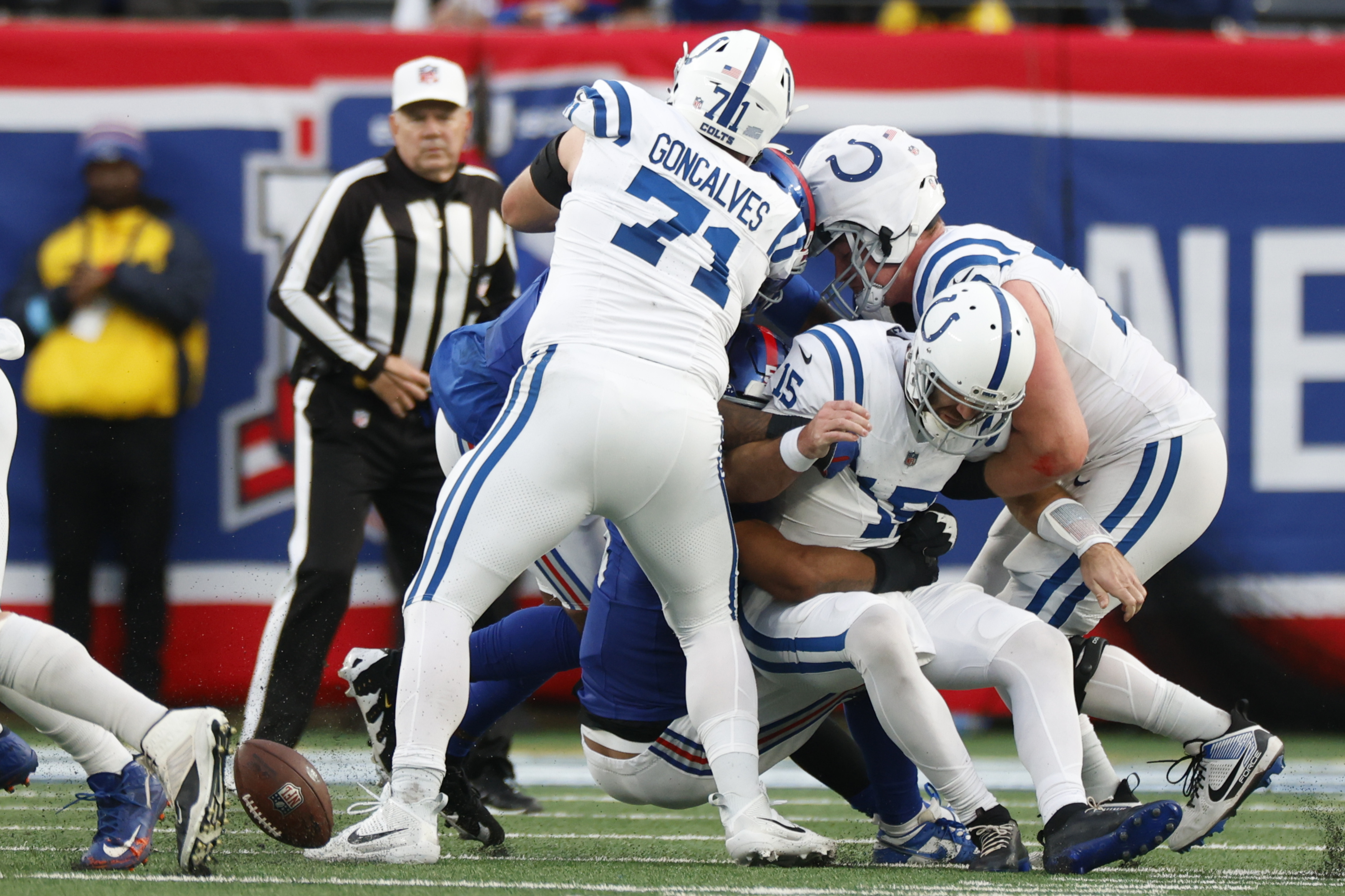 Indianapolis Colts quarterback Joe Flacco (15) is sacked and fumbles the ball to end the Colts' final drive in the fourth quarter of a 45-33 loss to the New York Giants in an NFL football game Sunday, Dec. 29, 2024, in East Rutherford, N.J.