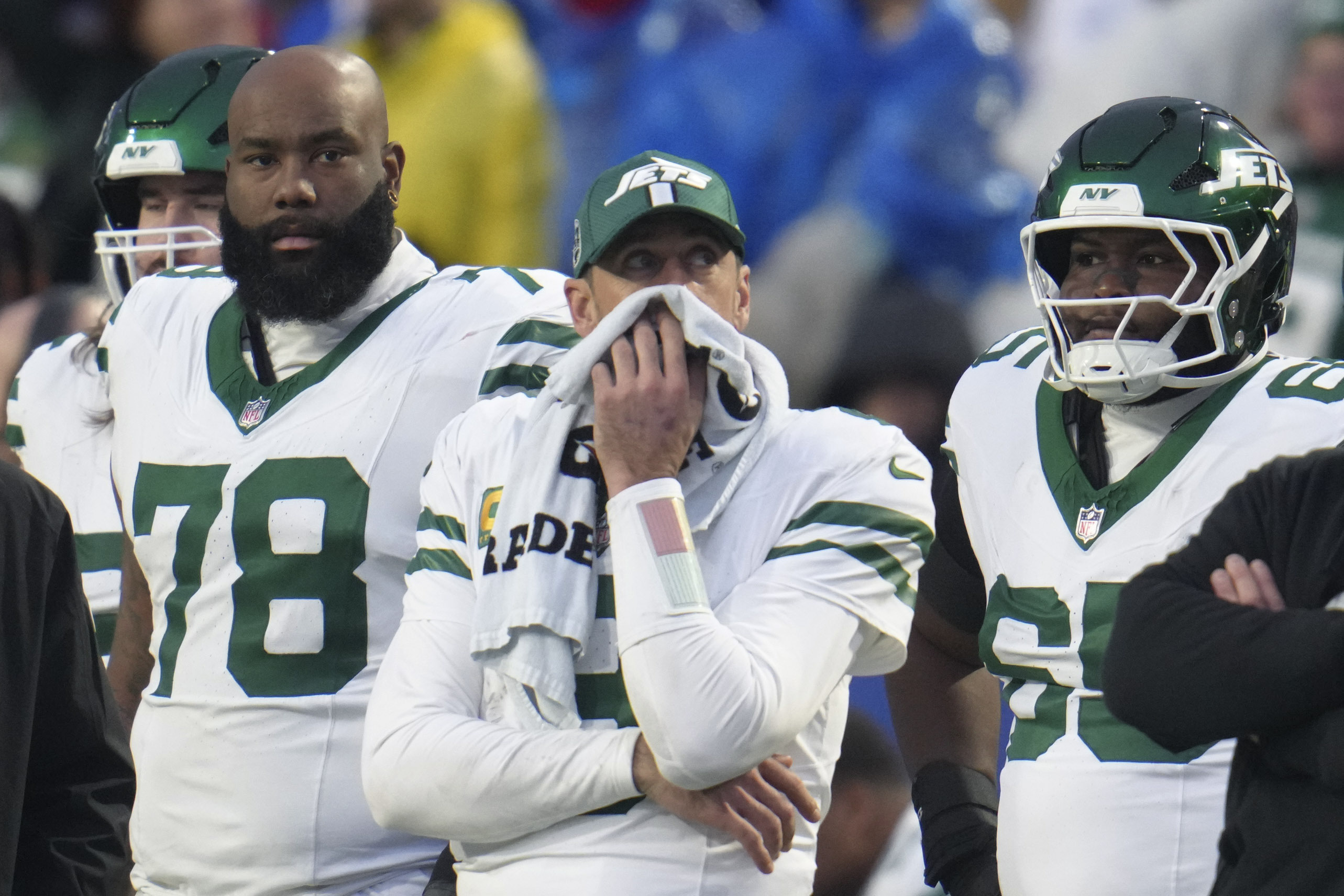 New York Jets quarterback Aaron Rodgers, center, stands on the sidelines after he was pulled from the game during the second half of an NFL football game against the Buffalo Bills, Sunday, Dec. 29, 2024, in Orchard Park, N.Y.
