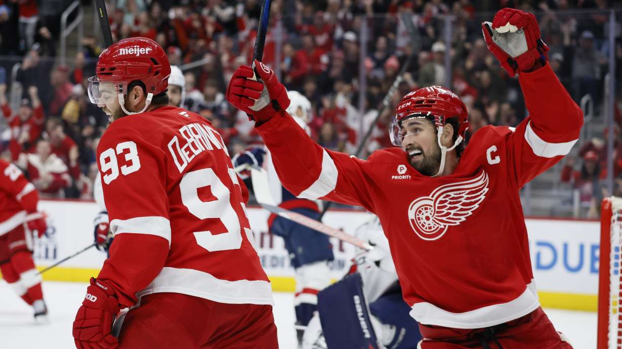 Detroit Red Wings center Dylan Larkin, right, and right wing Alex DeBrincat (93) celebrate a goal scored against the Washington Capitals by Patrick Kane during the first period of an NHL hockey game Sunday, Dec. 29, 2024, in Detroit.