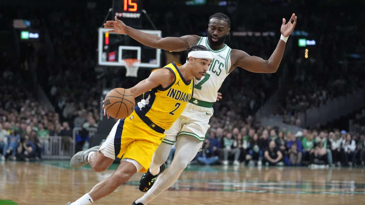 Indiana Pacers guard Andrew Nembhard (2) drives toward the basket in front of Boston Celtics guard Jaylen Brown (7) in the first half of an NBA basketball game, Sunday, Dec. 29, 2024, in Boston.