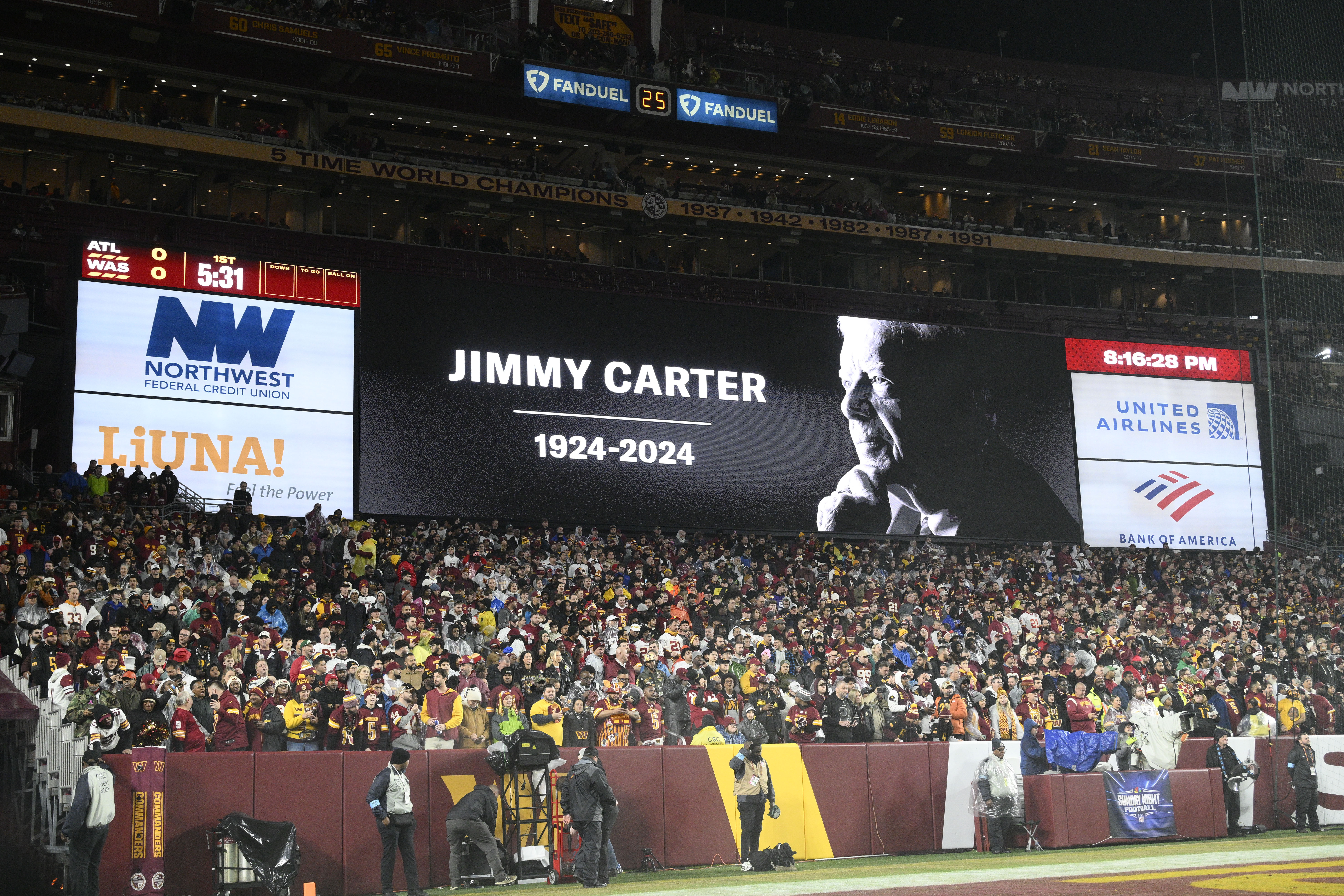 A video tribute to former President Jimmy Carter is seen before an NFL football game between the Washington Commanders and the Atlanta Falcons, Sunday, Dec. 29, 2024, in Landover.