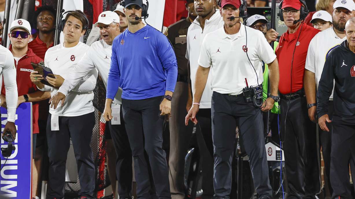 FILE - Oklahoma co-defensive coordinator Zac Alley, left, and head coach Brent Venables, right, watch their team play against Tennessee during the first half of an NCAA college football game, Sept. 21, 2024, in Norman, Okla.