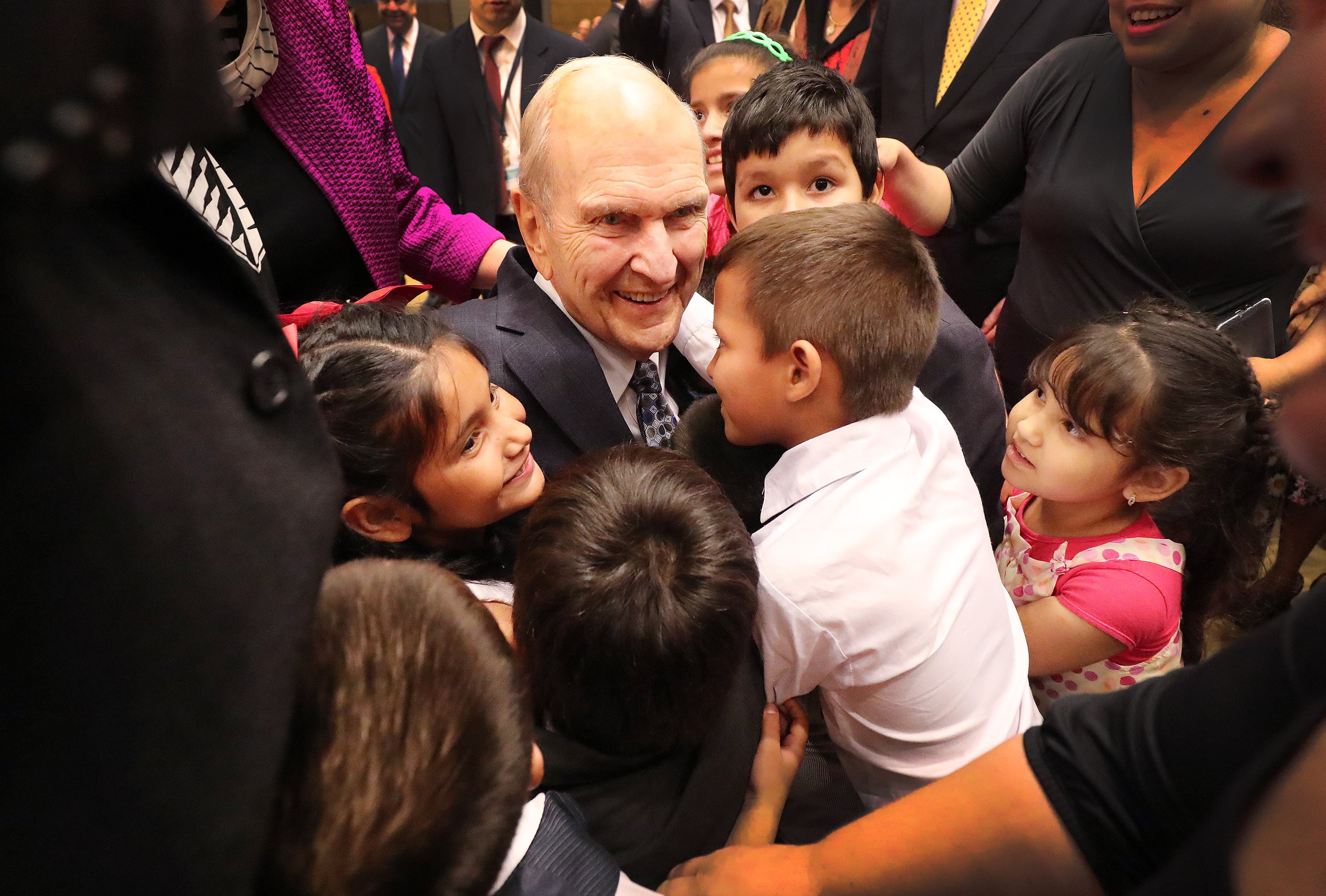 President Russell M. Nelson of The Church of Jesus Christ of Latter-day Saints hugs children after a devotional in Asuncion, Paraguay, on Oct. 22, 2018. Nelson died at the age of 101 in September.