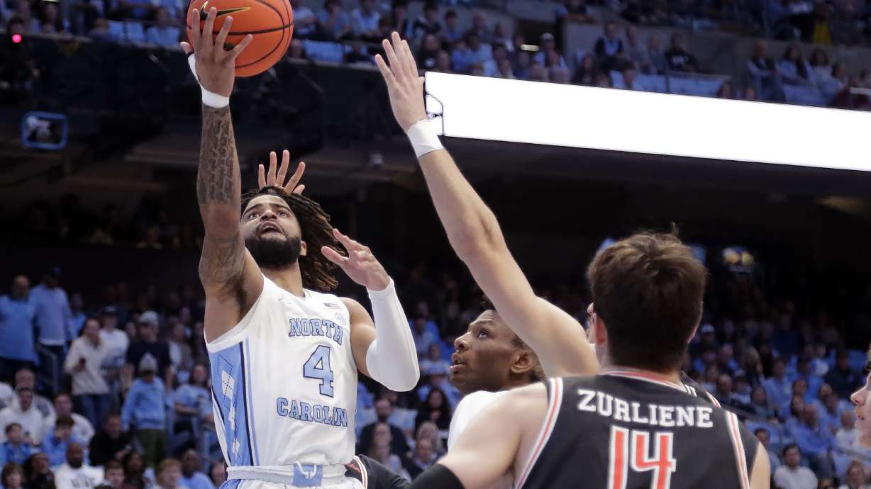 North Carolina guard RJ Davis (4) drives against Campbell guard Caleb Zurliene (14) during the first half of an NCAA college basketball game Sunday, Dec. 29, 2024, in Chapel Hill, N.C.