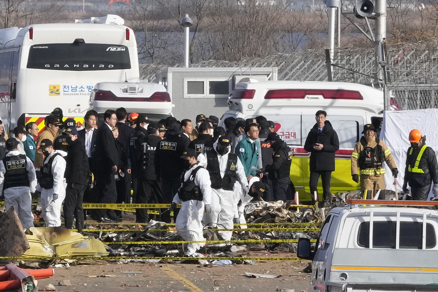 South Korea's acting President Choi Sang-mok, wearing a green jacket, visits the site of a plane fire at Muan International Airport in Muan, South Korea, Monday.