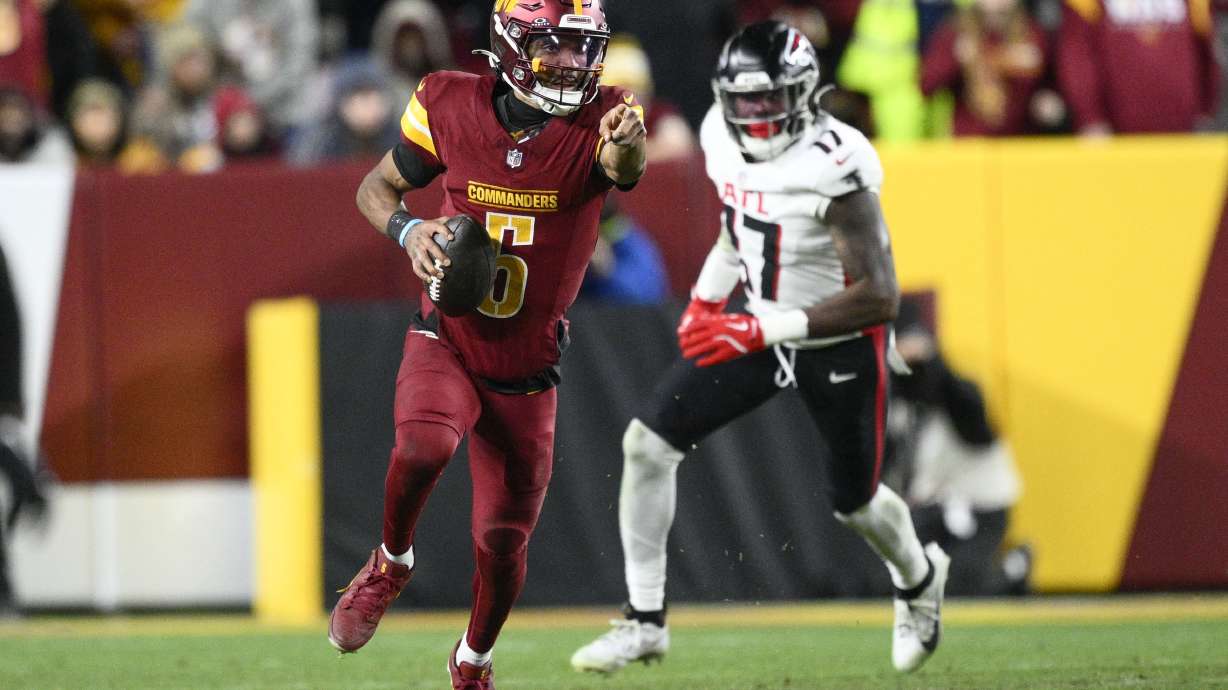 Washington Commanders quarterback Jayden Daniels (5) carries on a keeper during the second half of an NFL football game against the Atlanta Falcons, Sunday, Dec. 29, 2024, in Landover, Md.