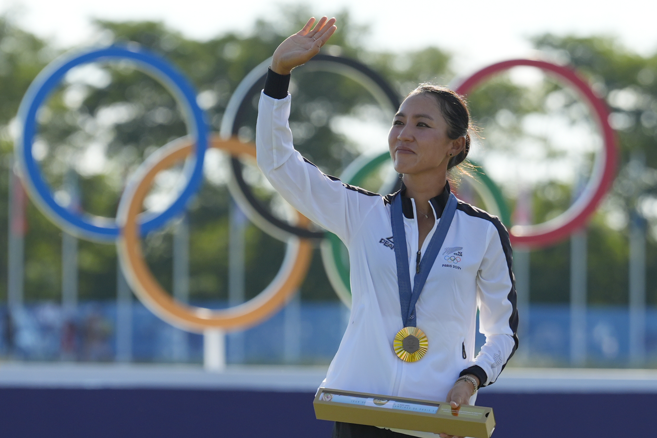 FILE -Lydia Ko, of New Zealand, waves to the crowd wearing her gold medal during the medal ceremony following the final round of the women's golf event at the 2024 Summer Olympics, Saturday, Aug. 10, 2024, at Le Golf National, in Saint-Quentin-en-Yvelines, France.