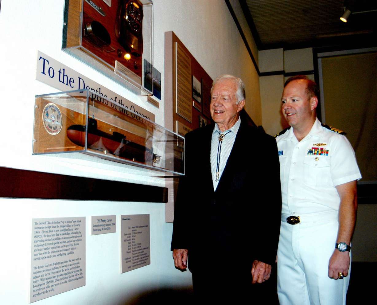 Former President Jimmy Carter, left, and Navy Cmdr. David Bartholomew Jr. look over a new display in Plains, Ga., Monday, Sept. 29, 2003. The display highlights Carter's naval career. Bartholomew is the captain of the USS Jimmy Carter, a new attack submarine named for the former president.