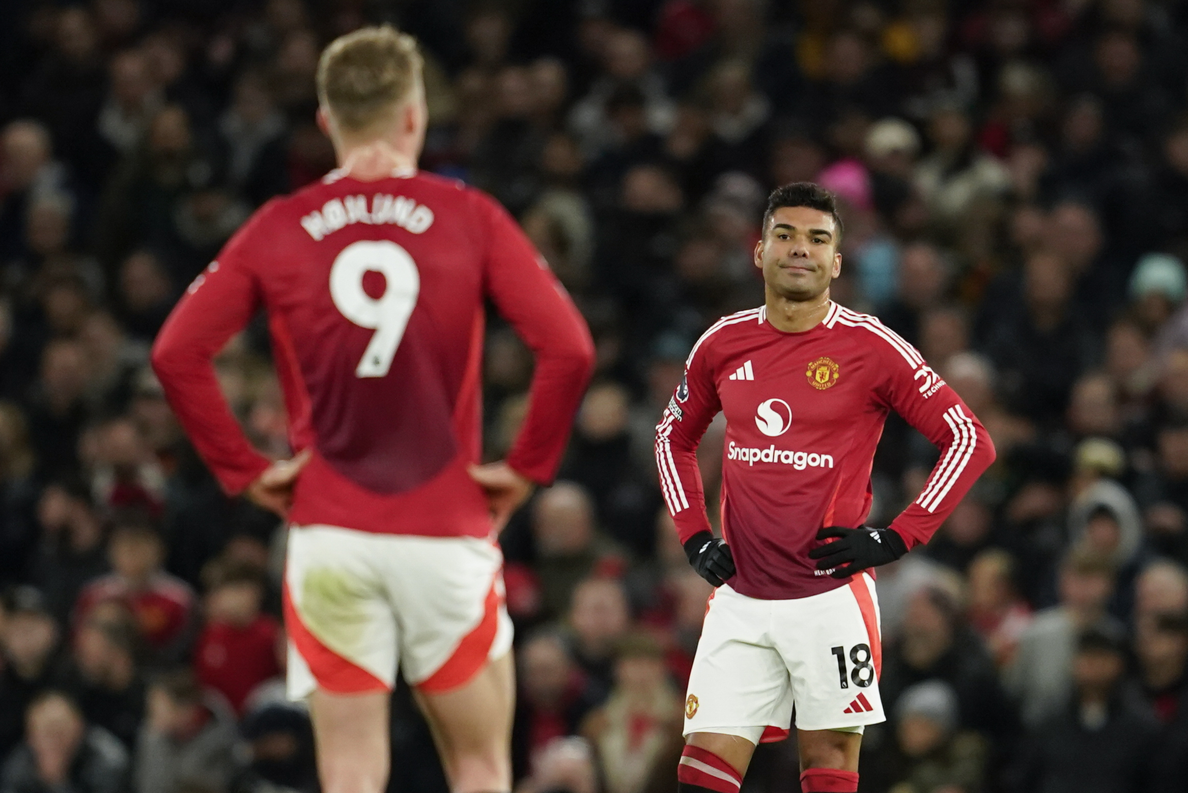 Manchester United's Casemiro, right, and Manchester United's Rasmus Hojlund react after Newcastle's Joelinton scoring his side's second goal during the English Premier League soccer match between Manchester United and Newcastle at the Old Trafford stadium in Manchester, England, Monday, Dec. 30, 2024.