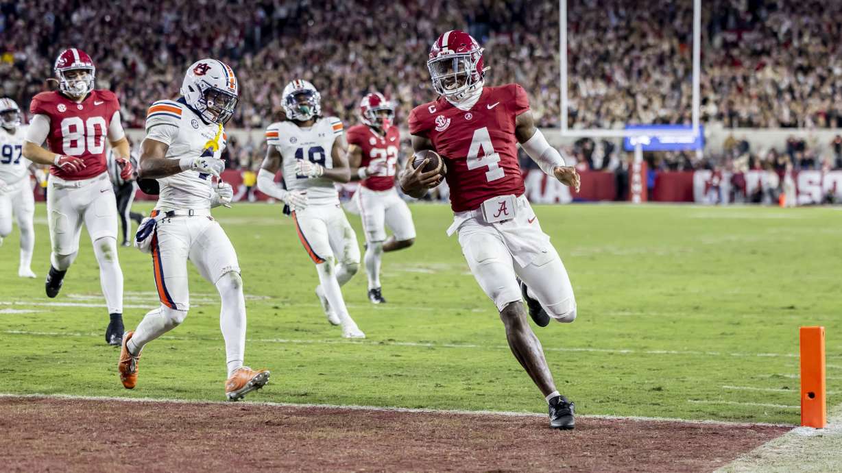Alabama quarterback Jalen Milroe (4) runs the ball for a touchdown against Auburn during the second half an NCAA college football game, Saturday, Nov. 30, 2024, in Tuscaloosa, Ala.