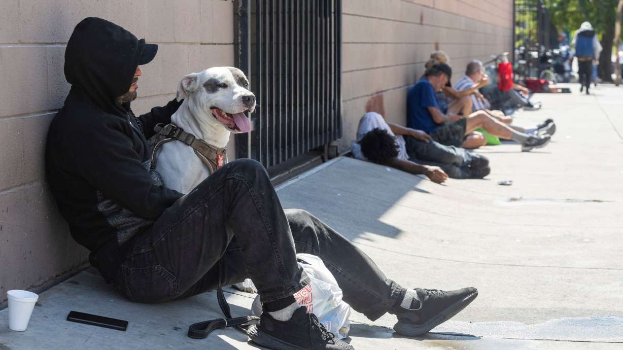 Hector and his dog King sit with other people outside of the St. Vincent de Paul Dining Hall and Weigand Resource Center in Salt Lake City on Sept. 9. Homelessness increased nationwide from January 2023 to January 2024, reaching a record level.