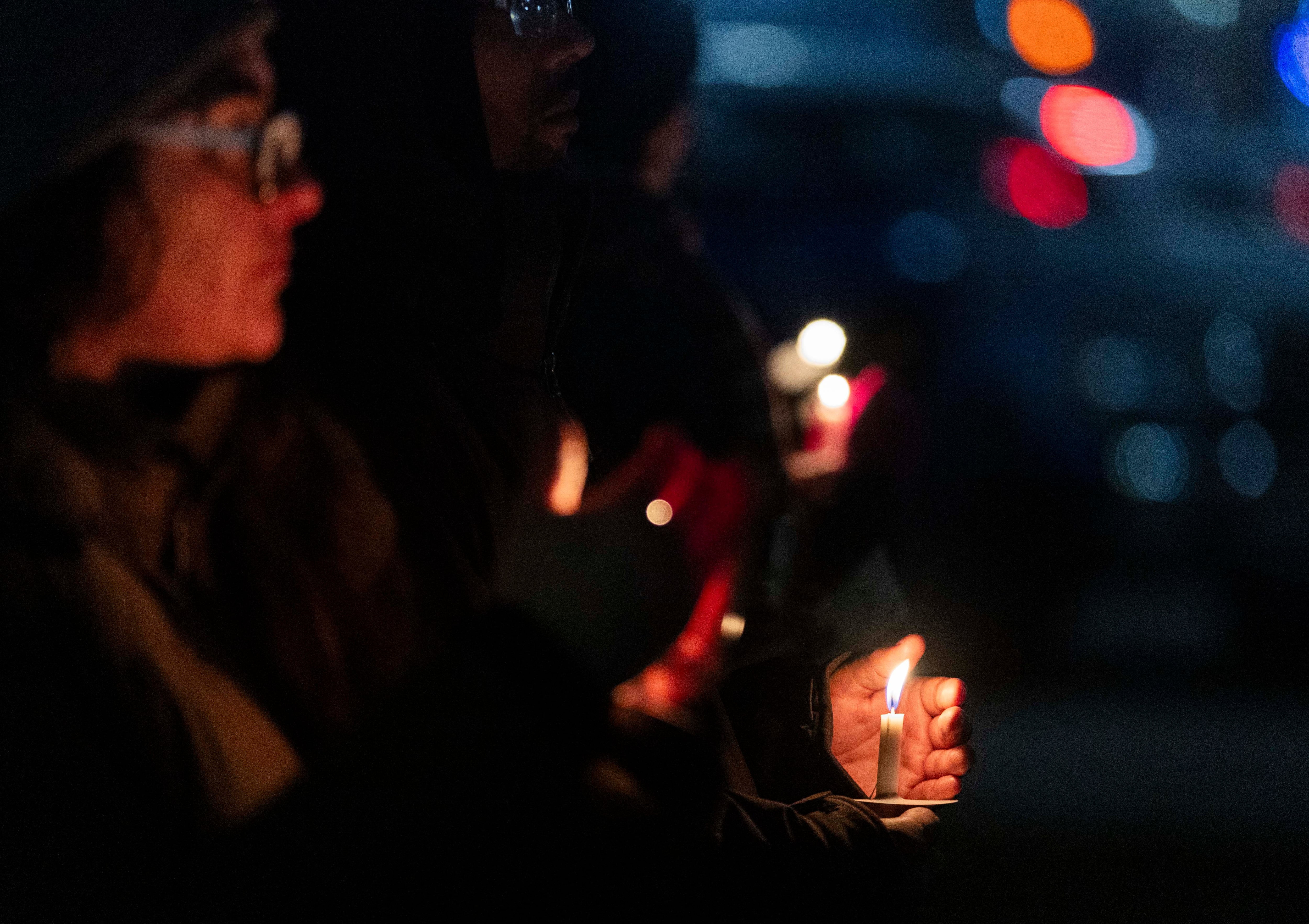 People hold vigil candles during the annual Homeless Persons’ Memorial Vigil, hosted by the Salt Lake Valley Coalition to End Homelessness, in Pioneer Park in Salt Lake City on Thursday, Dec. 19, 2024.