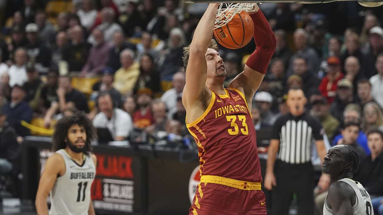 Iowa State forward Brandton Chatfield (33) dunks as Colorado guard Javon Ruffin, left, and forward Assane Diop, right, watch in the first half of an NCAA college basketball game Monday, Dec. 30, 2024, in Boulder, Colo.