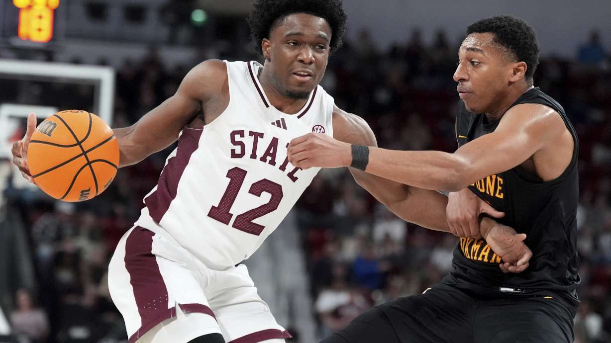 Mississippi State guard Josh Hubbard (12) fights off a steal-attempt by Bethune-Cookman guard Seneca Willoughby, right, during the first half of an NCAA college basketball game, Monday, Dec. 30, 2024, in Starkville, Miss.