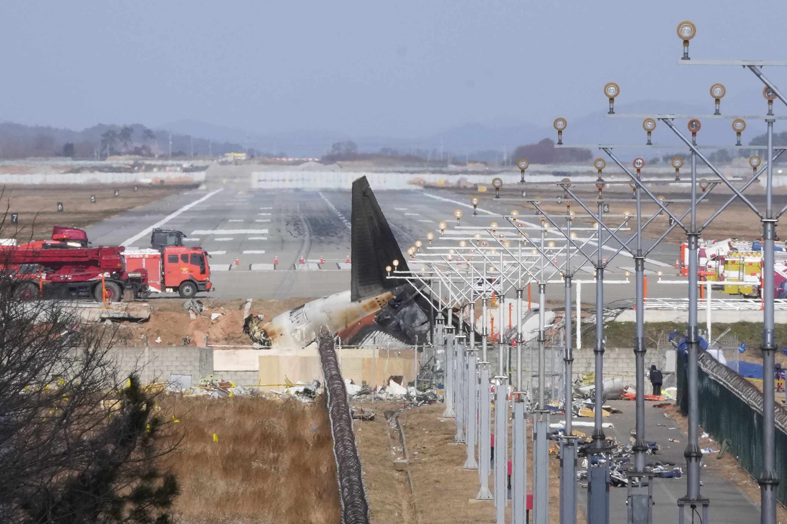 The wreckage of a Boeing 737-800 plane operated by South Korean budget airline Jeju Air lies at Muan International Airport in Muan, South Korea, Tuesday.