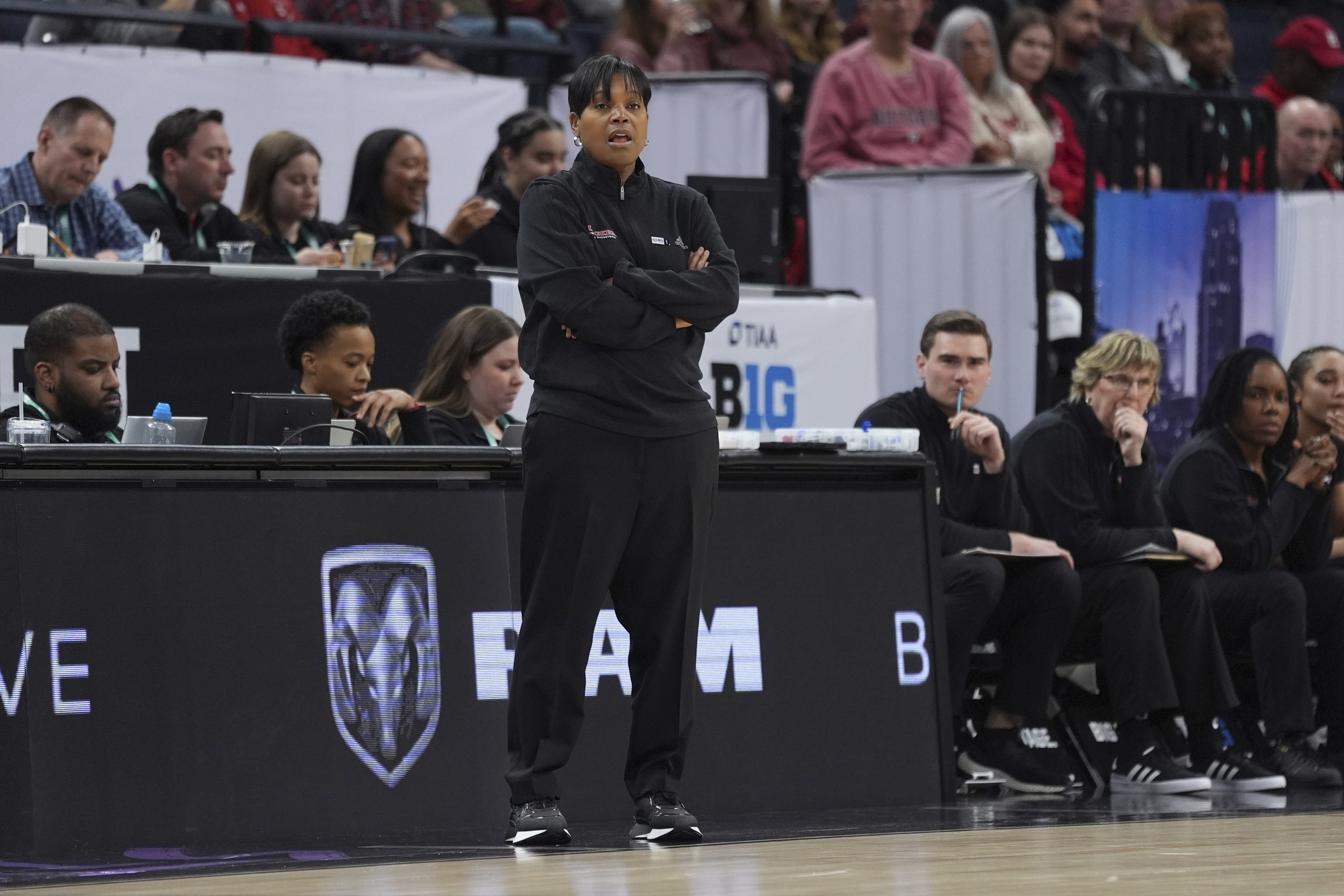 FILE - Rutgers coach Coquese Washington, center, watches play during the first half of the team's NCAA college basketball game against Minnesota at the Big Ten women's tournament, March 6, 2024, in Minneapolis.