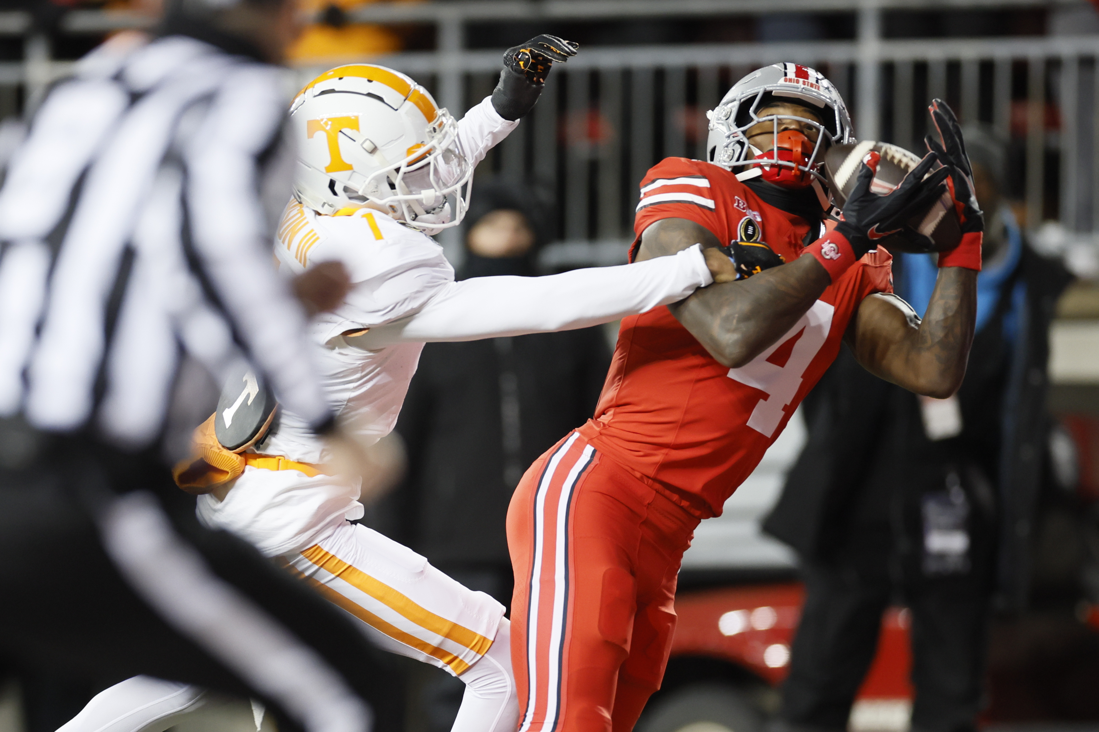 Ohio State receiver Jeremiah Smith, right, catches a touchdown pass against Tennessee defensive back Rickey Gibson, second from right, during the first half in the first round of the College Football Playoff, Saturday, Dec. 21, 2024, in Columbus, Ohio. 