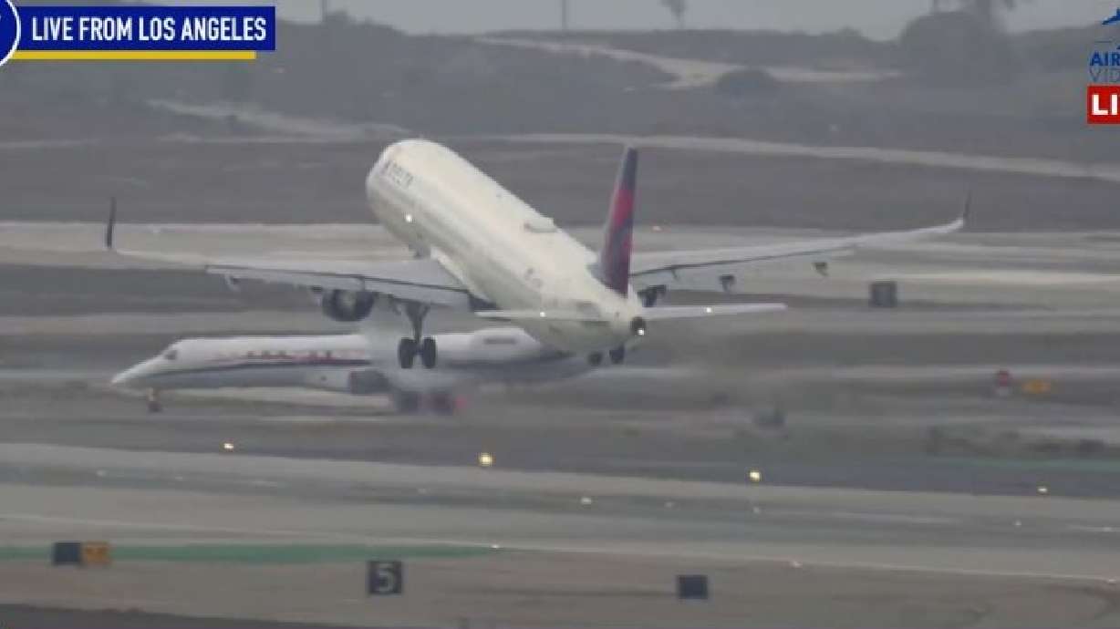 This still image taken from video shows the Gonzaga University men's basketball team plane, back left, taxiing and being told to stop on the runway at Los Angeles International Airport on Dec. 27 in Los Angeles.