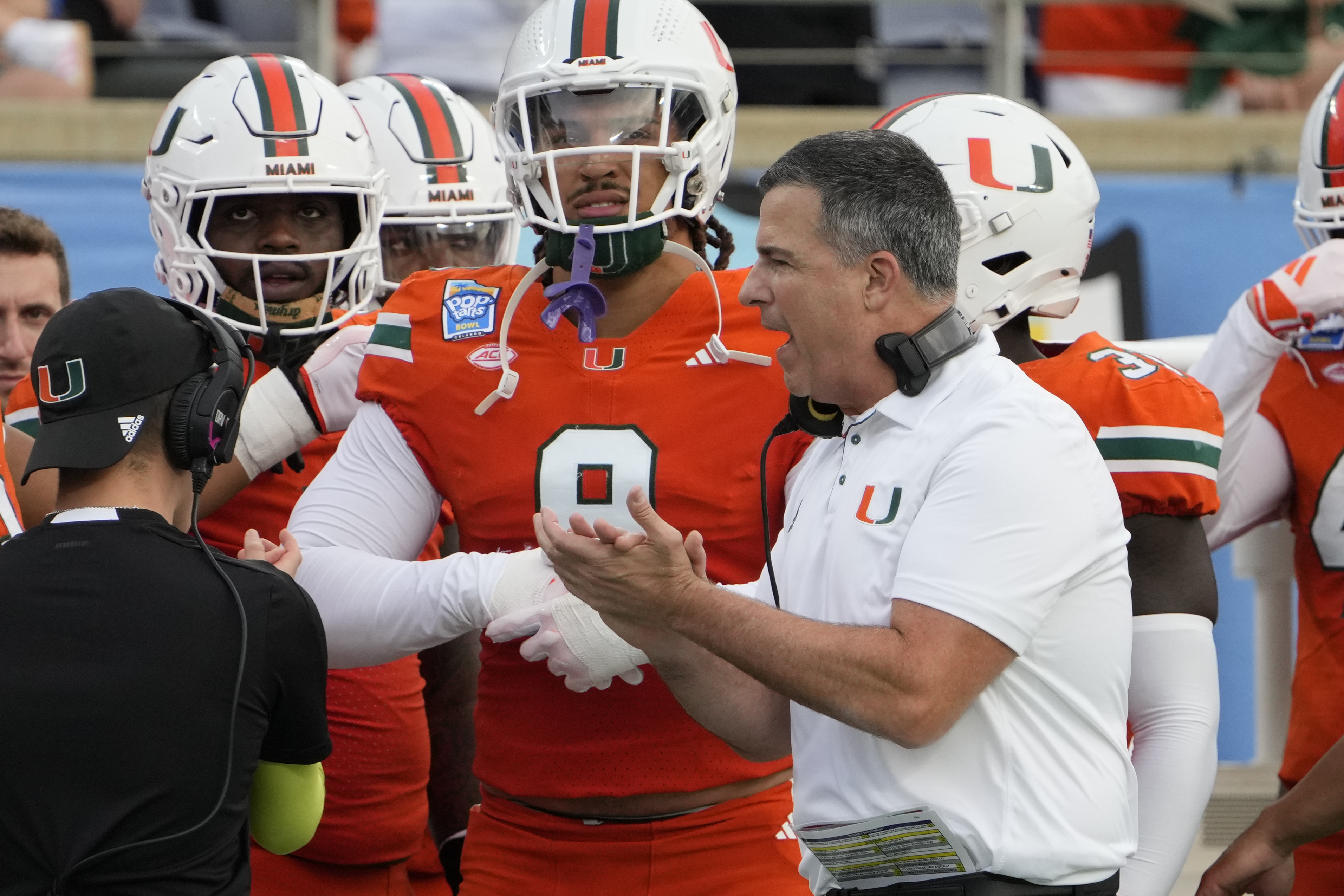 Miami head coach Mario Cristobal encourages his players as he paces the sideline during the first half of the Pop Tarts Bowl NCAA college football game against Iowa State, Saturday, Dec. 28, 2024, in Orlando, Fla.