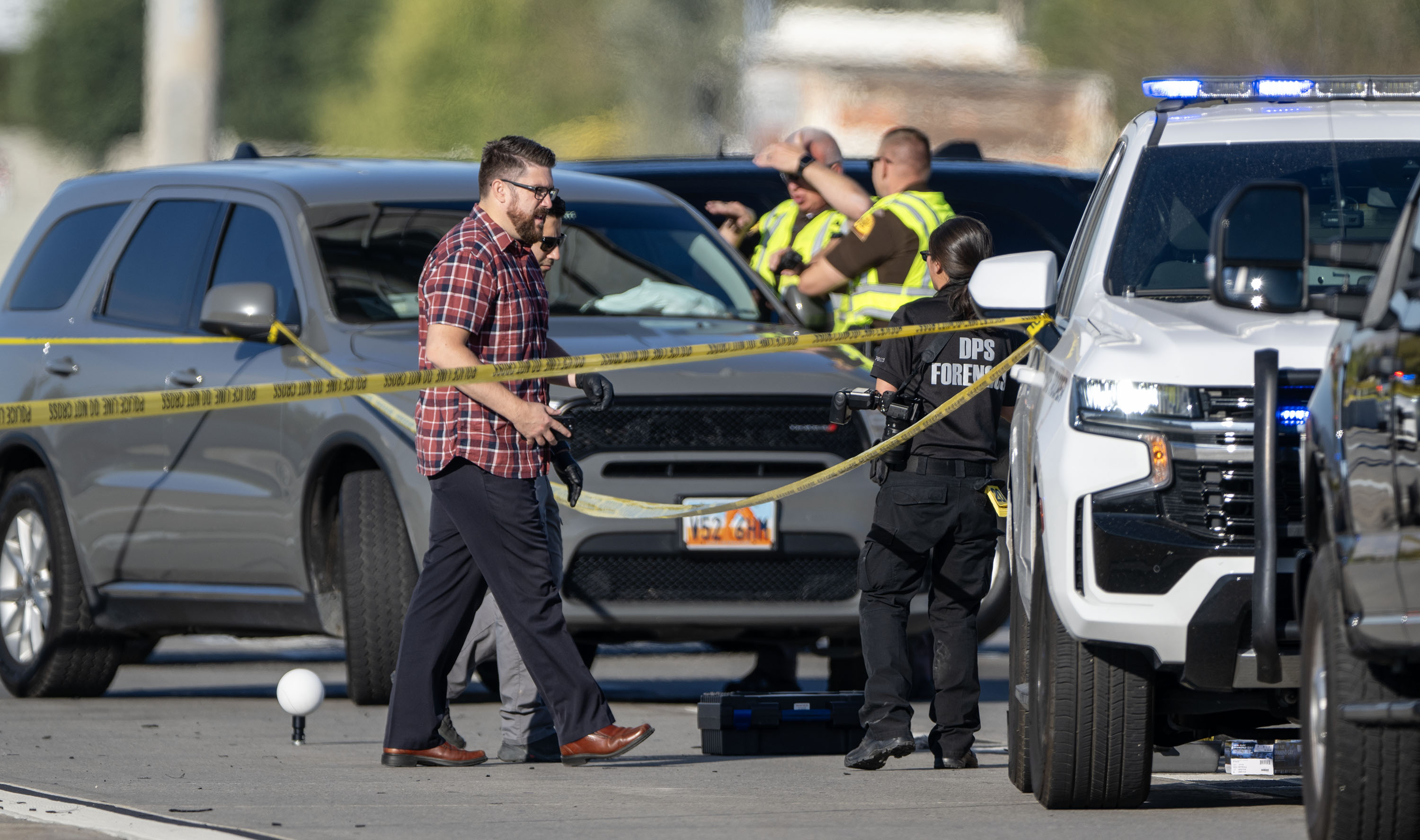 Law enforcement officials investigate after a fatal road rage shooting on state Route 201 near 900 West in Salt Lake City on Oct. 7, 2024.