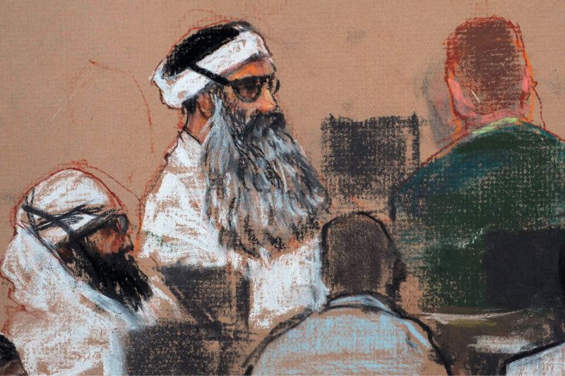 This Dec. 8, 2008, courtroom drawing depicts Khalid Sheikh Mohammed, center, and co-defendant Walid Bin Attash, left, attending a pre-trial session at Guantanamo Bay Naval Base, Cuba.