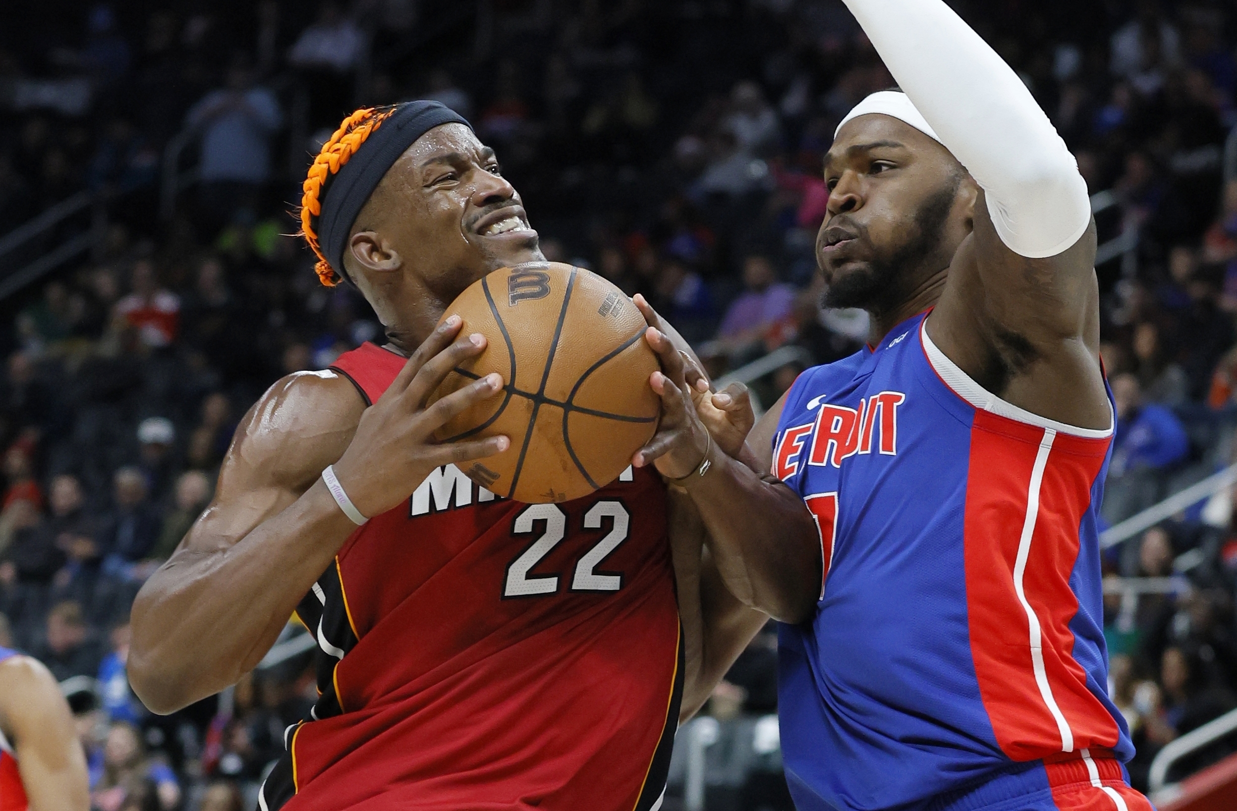 Miami Heat forward Jimmy Butler (22) drives to the basket against Detroit Pistons forward Paul Reed, right, during the first half of an NBA basketball game Monday, Dec. 16, 2024, in Detroit.
