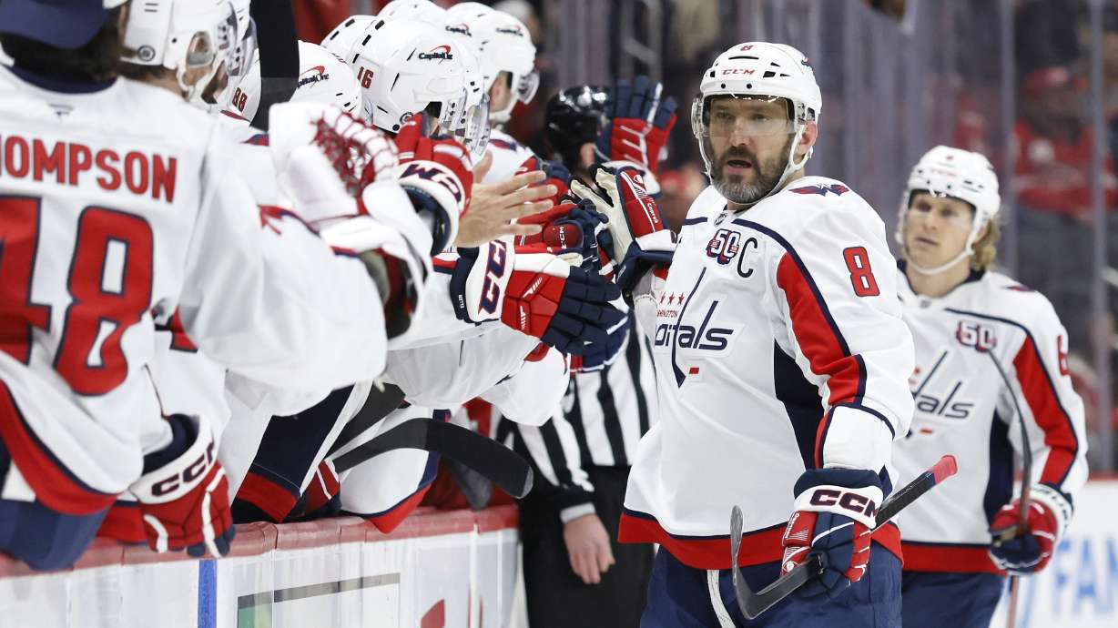 Washington Capitals left wing Alex Ovechkin (8) celebrates with teammates after scoring against the Detroit Red Wings during the first period of an NHL hockey game Sunday, Dec. 29, 2024, in Detroit.