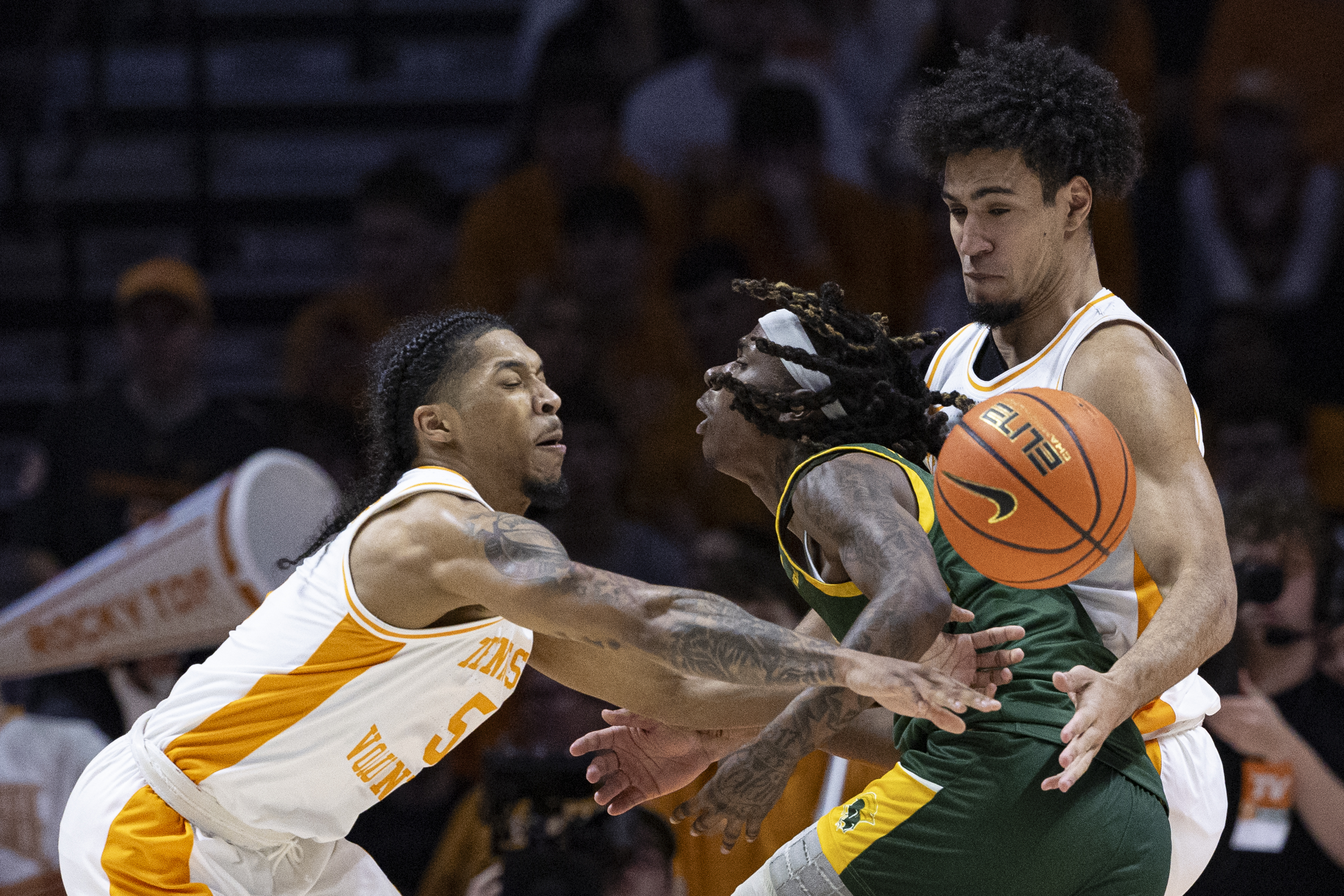 Norfolk State guard Sin'Cere McMahon (13) has the ball knocked away as he's defended by Tennessee guards Zakai Zeigler (5) and Bishop Boswell (3) during the first half of an NCAA college basketball game Tuesday, Dec. 31, 2024, in Knoxville, Tenn. 