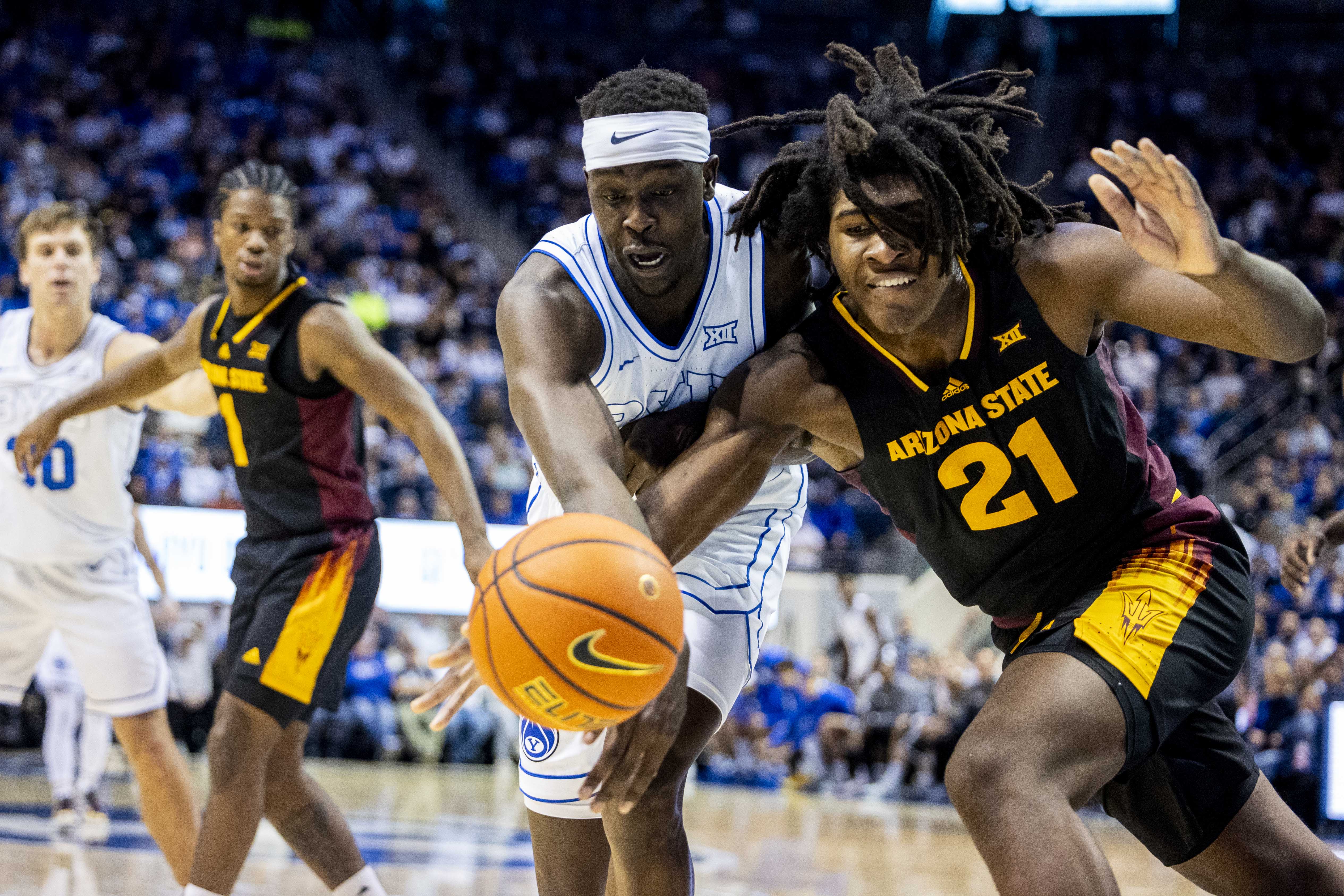 BYU forward Mawot Mag (0) and Arizona State forward Jayden Quaintance (21) compete for possession of a loose ball during an NCAA men’s basketball game held at the Marriott Center in Provo on Tuesday, Dec. 31, 2024.