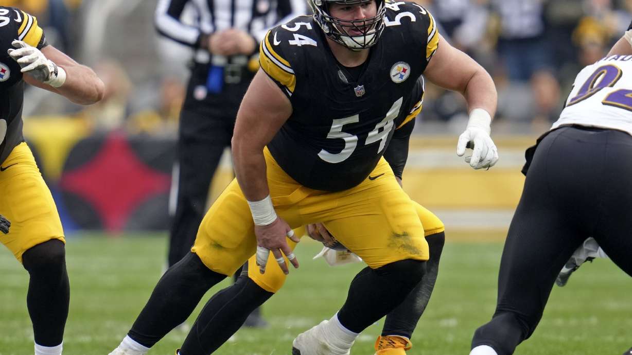 FILE - Pittsburgh Steelers center Zach Frazier (54) snaps the ball to quarterback Russell Wilson (3) during the first half of an NFL football game against the Baltimore Ravens, Sunday, Nov. 17, 2024, in Pittsburgh.