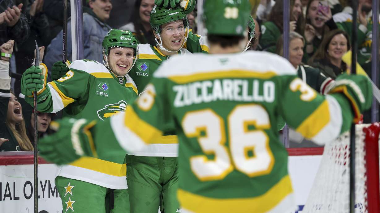 Minnesota Wild center Marco Rossi, left, celebrates his goal with teammates during the first period of an NHL hockey game against the Nashville Predators Tuesday, Dec. 31, 2024, in St. Paul, Minn.