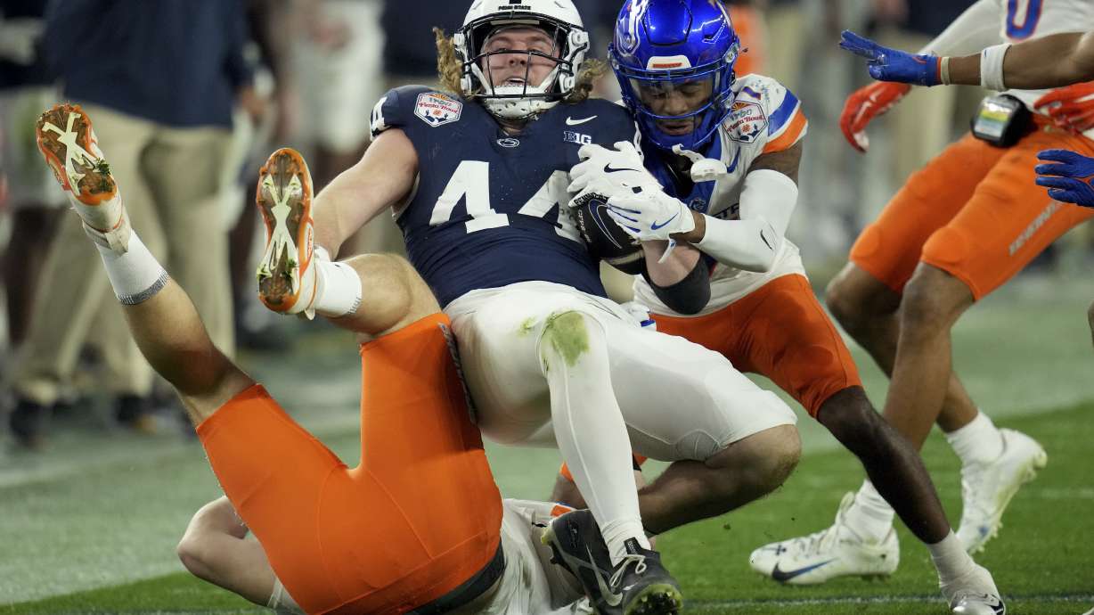 Penn State tight end Tyler Warren (44) is tackled by Boise State defensive end Max Stege (95) during the first half of the Fiesta Bowl NCAA college football CFP quarterfinal game, Tuesday, Dec. 31, 2024, in Glendale, Ariz.