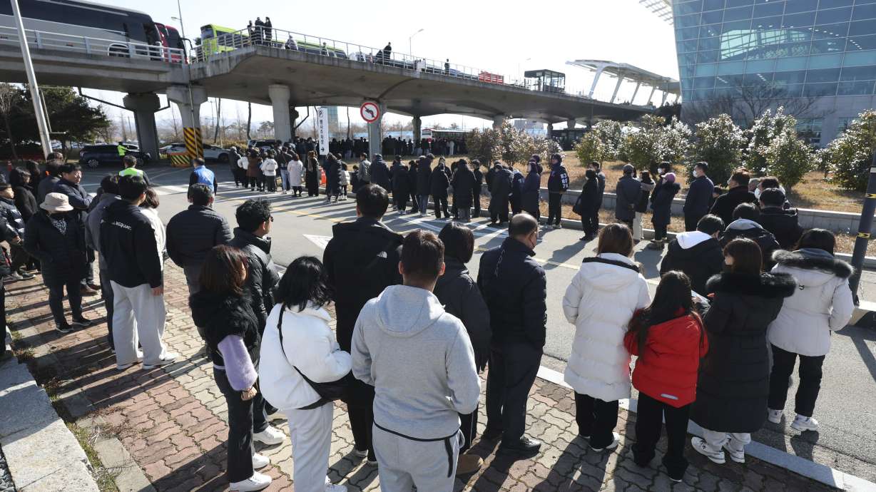 Mourners wait to pay tribute to the victims of a plane fire at a memorial altar at Muan International Airport in Muan, South Korea, Wednesday.