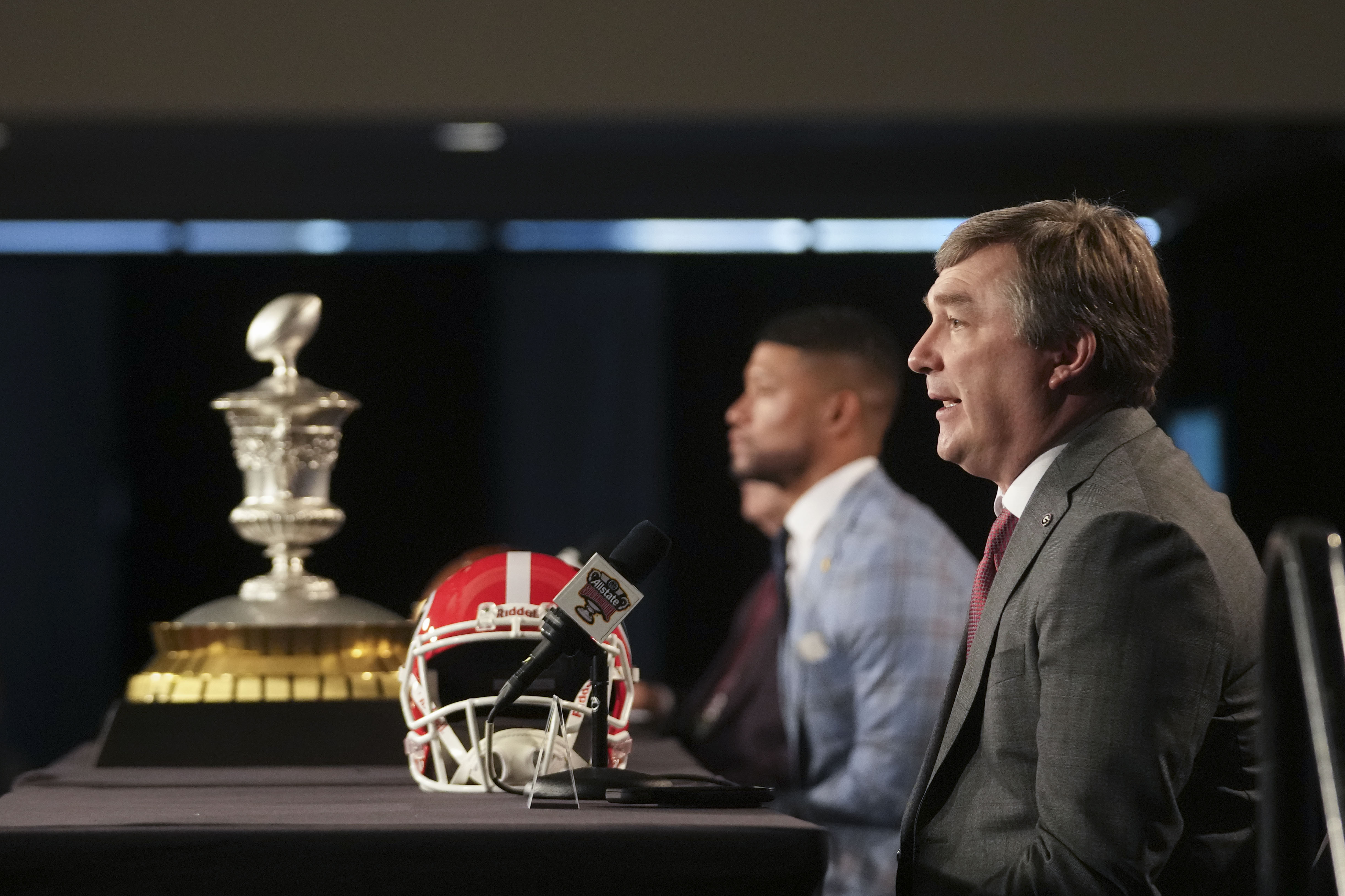 Georgia head coach Kirby Smart speaks to reporters with Notre Dame head coach Marcus Freeman, background, in New Orleans, on Tuesday. Georgia will face Notre Dame in the Sugar Bowl NCAA college football CFP quarterfinal game now postponed until Thursday.