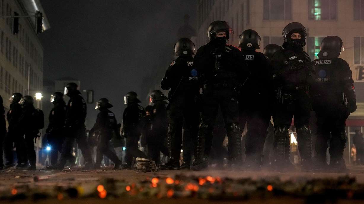 Police officers stand guard in the streets after fireworks celebrations in Berlin, Germany, on Wednesday.