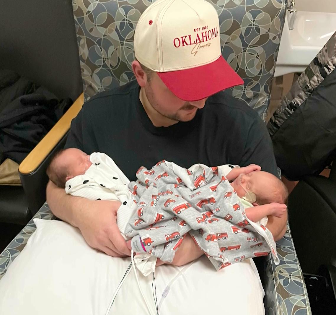 Sam Hughes holds his newborn twins in the NICU. His wife and their mother, Morgan Hughes, died unexpectedly on Saturday, from heart failure days after delivering the twins.