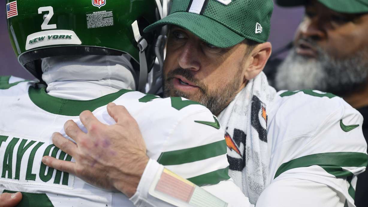 New York Jets quarterback Aaron Rodgers, left, hugs teammate quarterback Tyrod Taylor (2) after a touchdown during the second half of an NFL football game against the Buffalo Bills, Sunday, Dec. 29, 2024, in Orchard Park, N.Y.