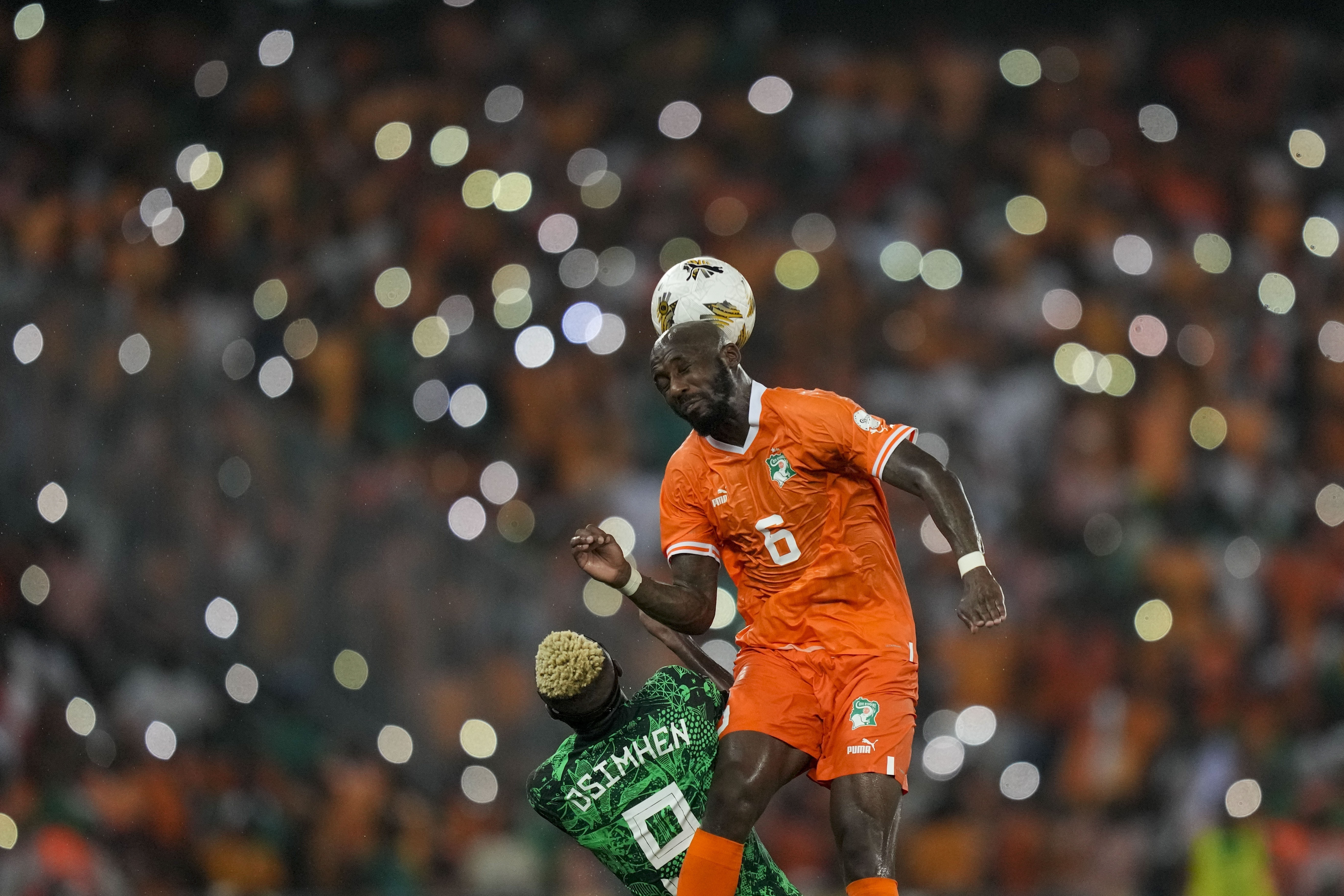 Ivory Coast 's Seko Fofana, top, duels for the ball with Nigeria's Victor Osimhen during the African Cup of Nations final soccer match between Nigeria and Ivory Coast, at the Olympic Stadium of Ebimpe in Abidjan, Ivory Coast, Sunday, Feb. 11, 2024.