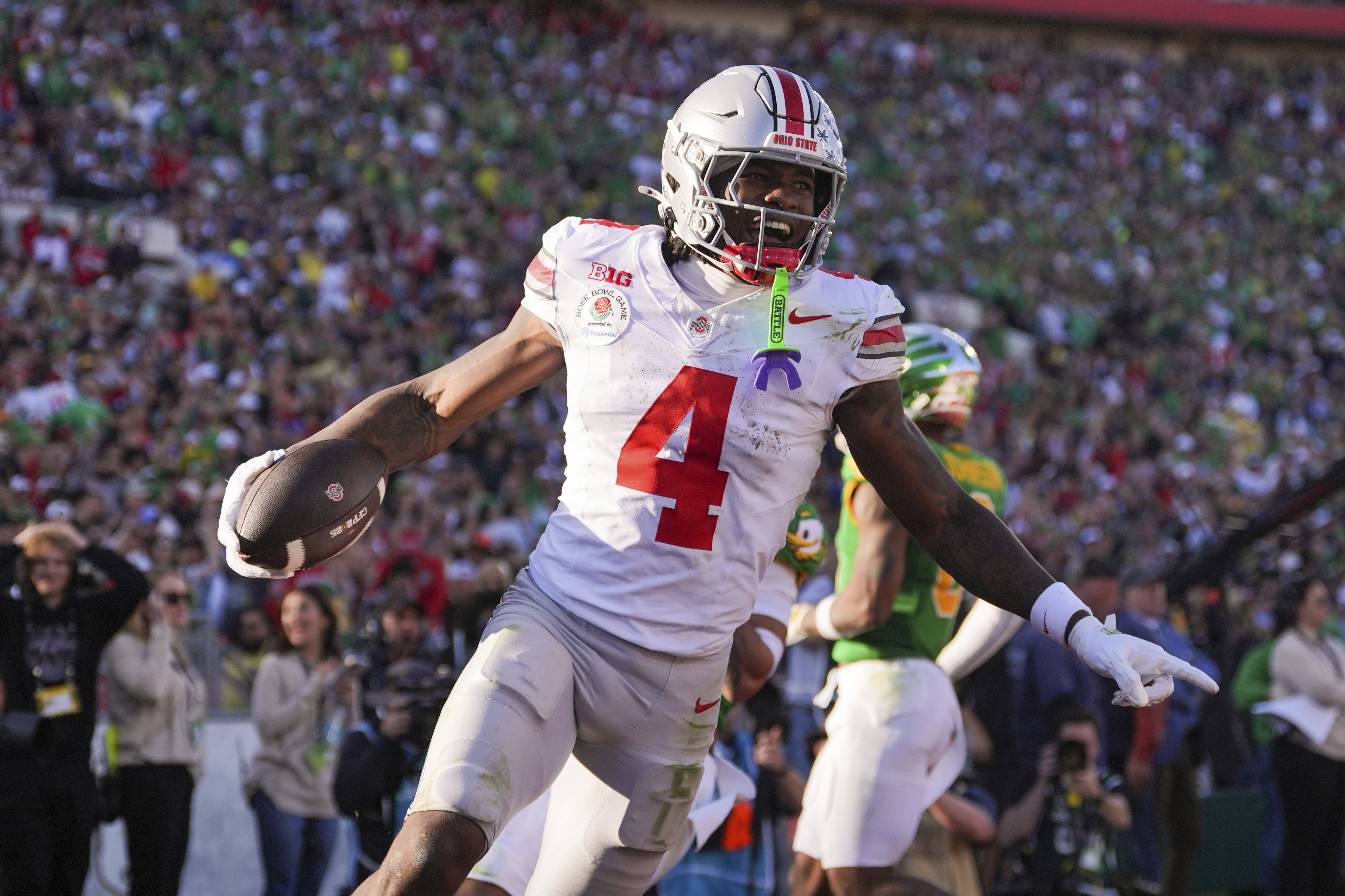 Ohio State wide receiver Jeremiah Smith (4) celebrates his touchdown against Oregon during the first half in the quarterfinals of the Rose Bowl College Football Playoff, Wednesday, Jan. 1, 2025, in Pasadena, Calif.