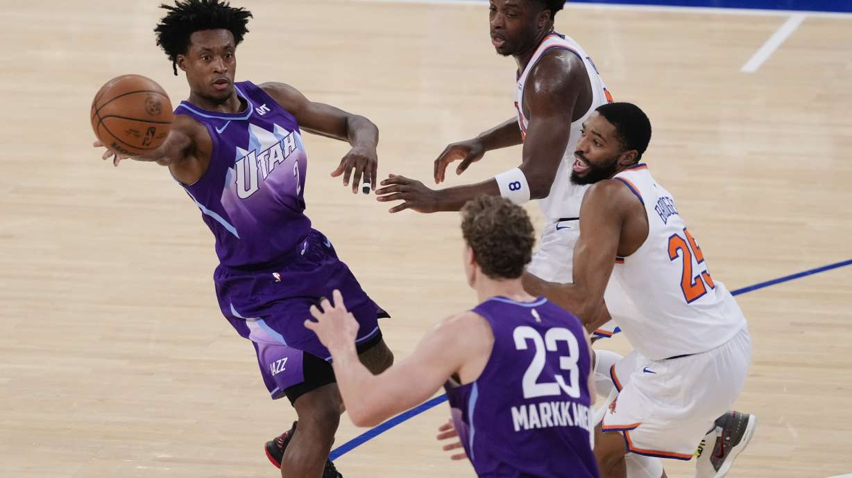 Utah Jazz's Collin Sexton (2) passes the ball away from New York Knicks' OG Anunoby and New York Knicks' Mikal Bridges (25) to teammate Lauri Markkanen (23) during the first half of an NBA basketball game Wednesday, Jan. 1, 2025, in New York.