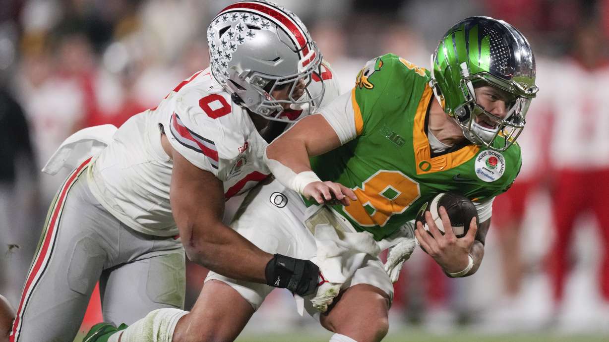 Ohio State linebacker Cody Simon (0) sacks Oregon quarterback Dillon Gabriel (8) during the second half in the quarterfinals of the Rose Bowl College Football Playoff, Wednesday, Jan. 1, 2025, in Pasadena, Calif.