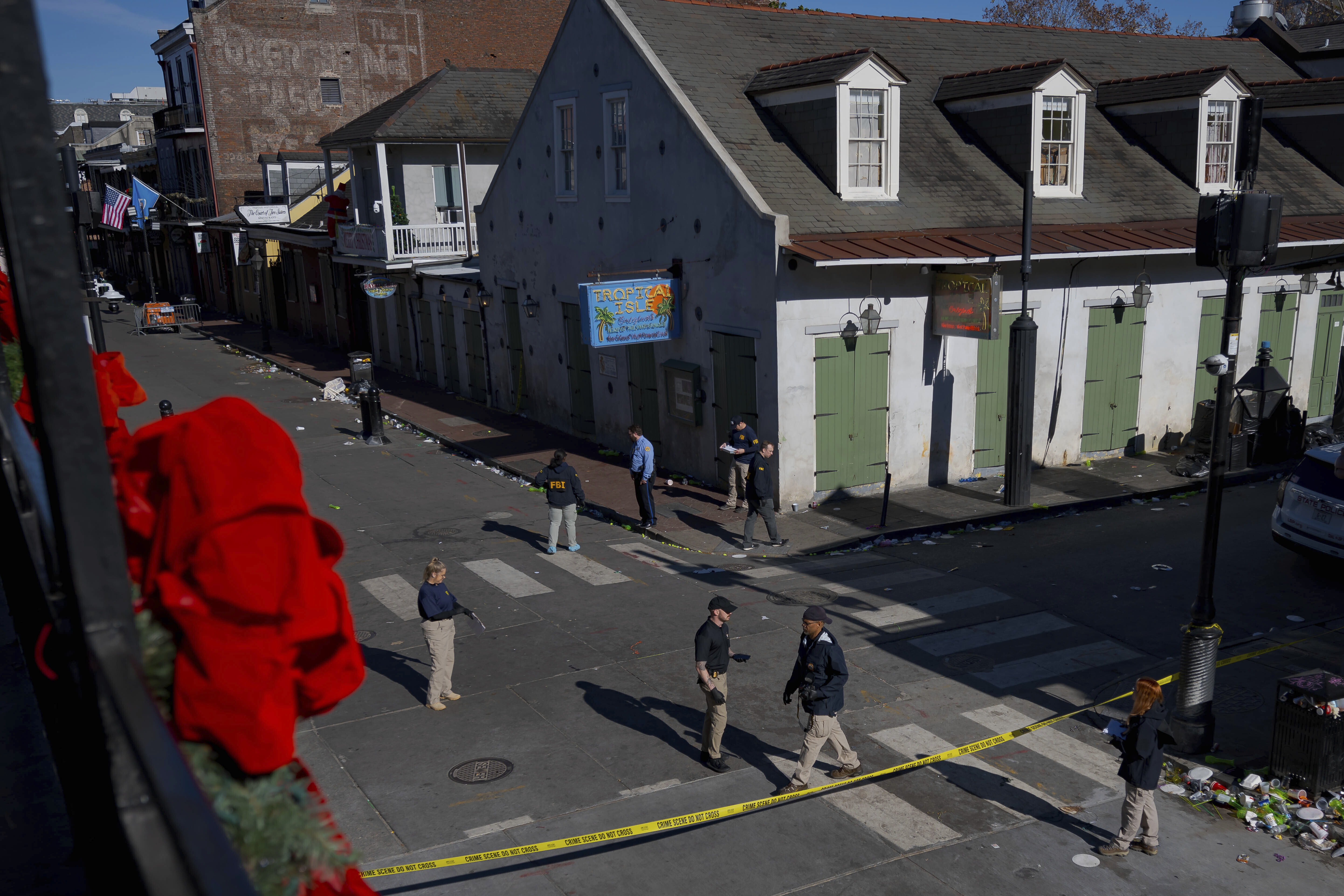 Members of the FBI walk around Bourbon Street during the investigation of a truck fatally crashing into pedestrians on Bourbon Street in the French Quarter in New Orleans, Wednesday.