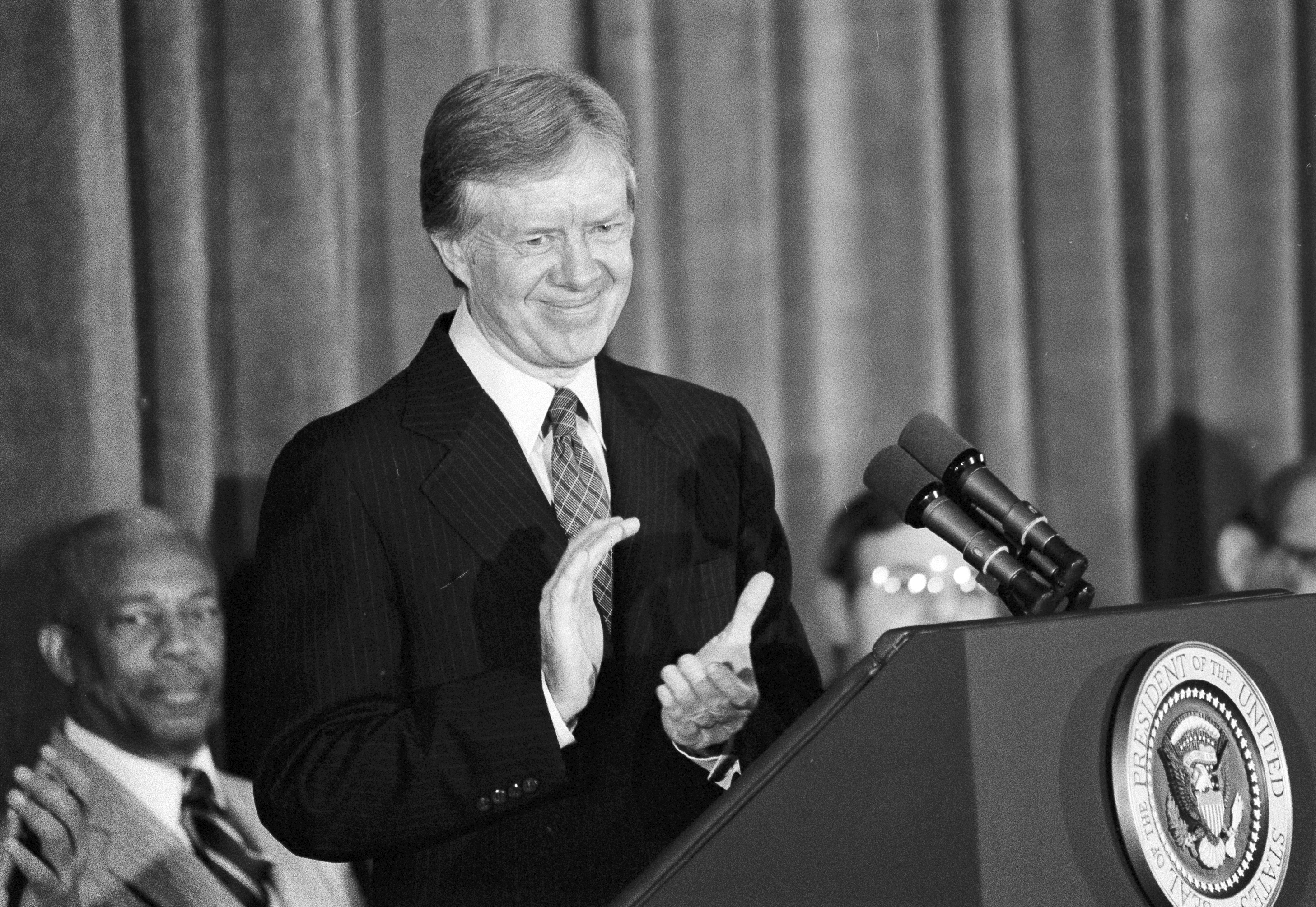 FILE - President Jimmy Carter pauses during a speech to applaud the U.S. Olympic Committee's stand on the Moscow Olympics, Feb. 1, 1980, in Washington.
