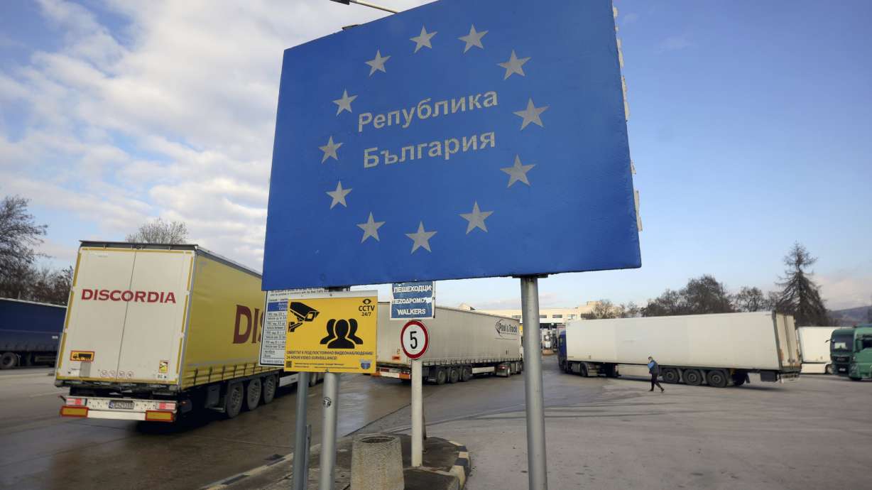 Trucks queue next to a sign reading ''Republic of Bulgaria'', at Bulgarian-Greece border checkpoint Kulata, Bulgaria, Thursday, Dec. 12, 2024.