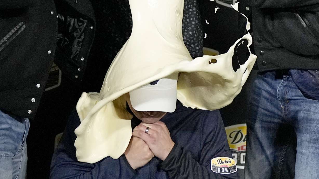 FILE - West Virginia head coach Neal Brown is dunked with mayonnaise after the team's win against North Carolina in an NCAA college football game at the Duke's Mayo Bowl Wednesday, Dec. 27, 2023, in Charlotte, N.C.