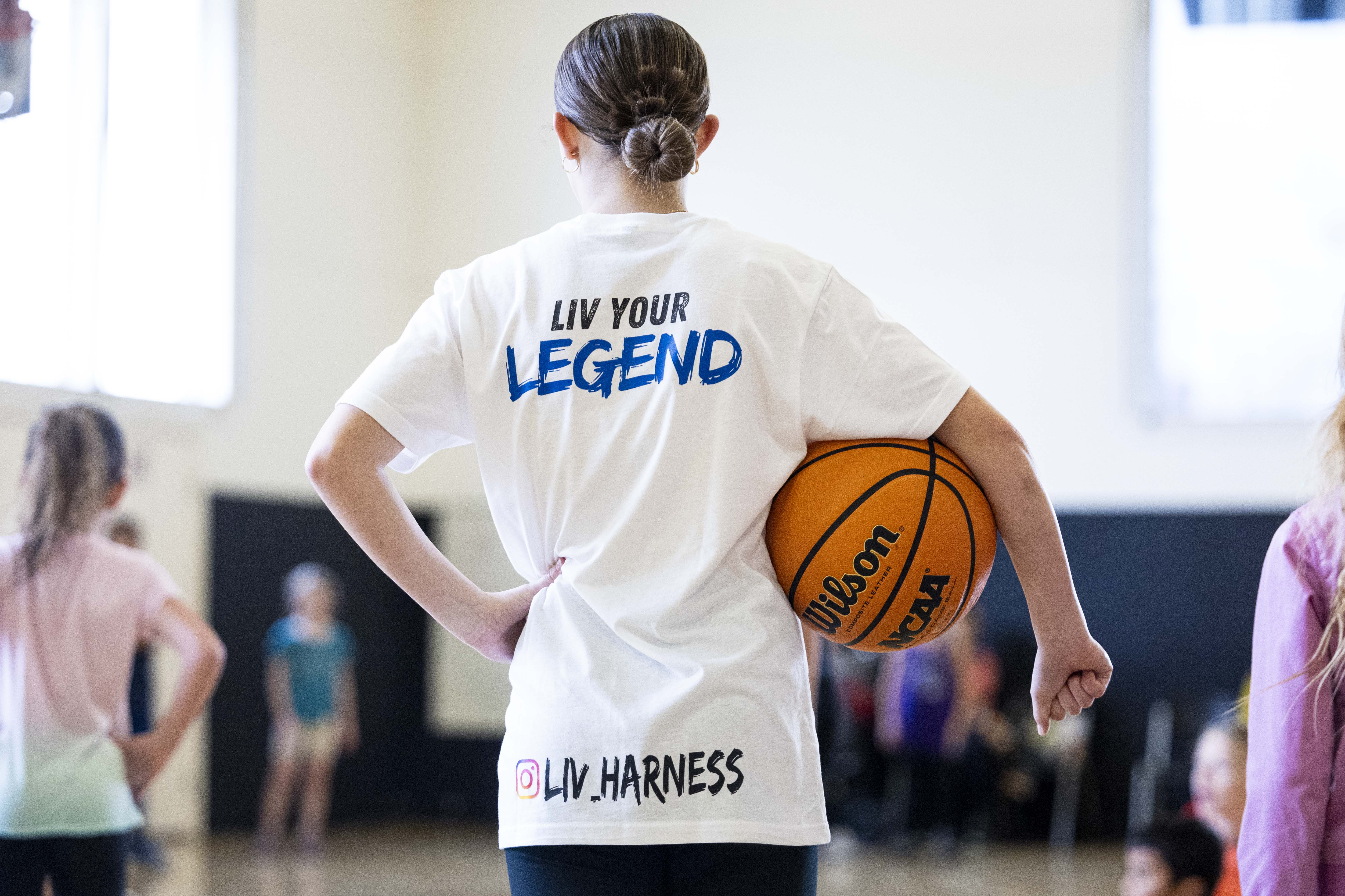 Liv Harness, 14, watches a warm-up activity during a basketball camp for children with Utah Foster Care and Raise the Future held at the Karl Malone Training Center in Lehi on Thursday.