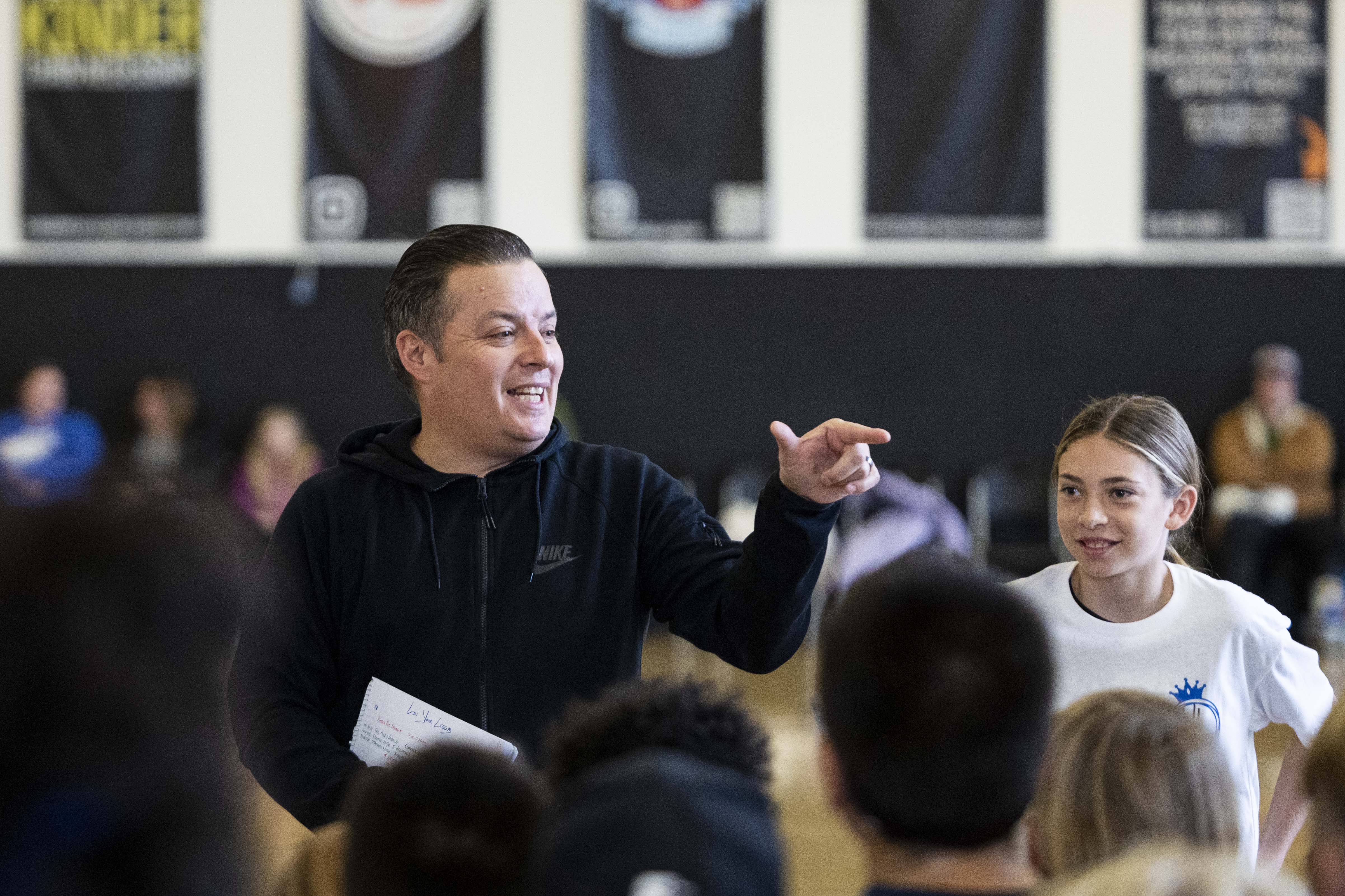 Mike Harness talks with all attendees at the start of a basketball camp for children with Utah Foster Care and Raise the Future held at the Karl Malone Training Center in Lehi on Thursday.